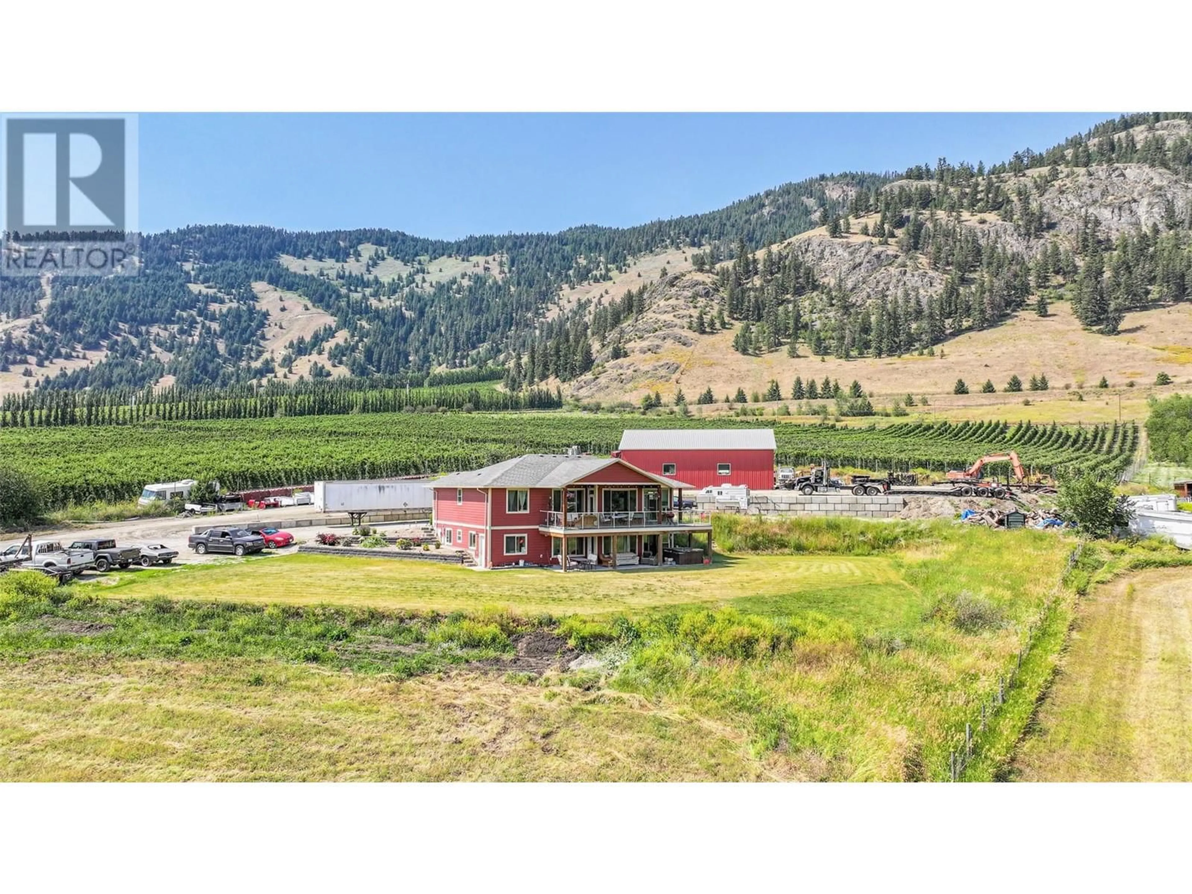 A pic from outside/outdoor area/front of a property/back of a property/a pic from drone, mountain view for 6205 6 HIGHWAY, Coldstream British Columbia V1B3C7