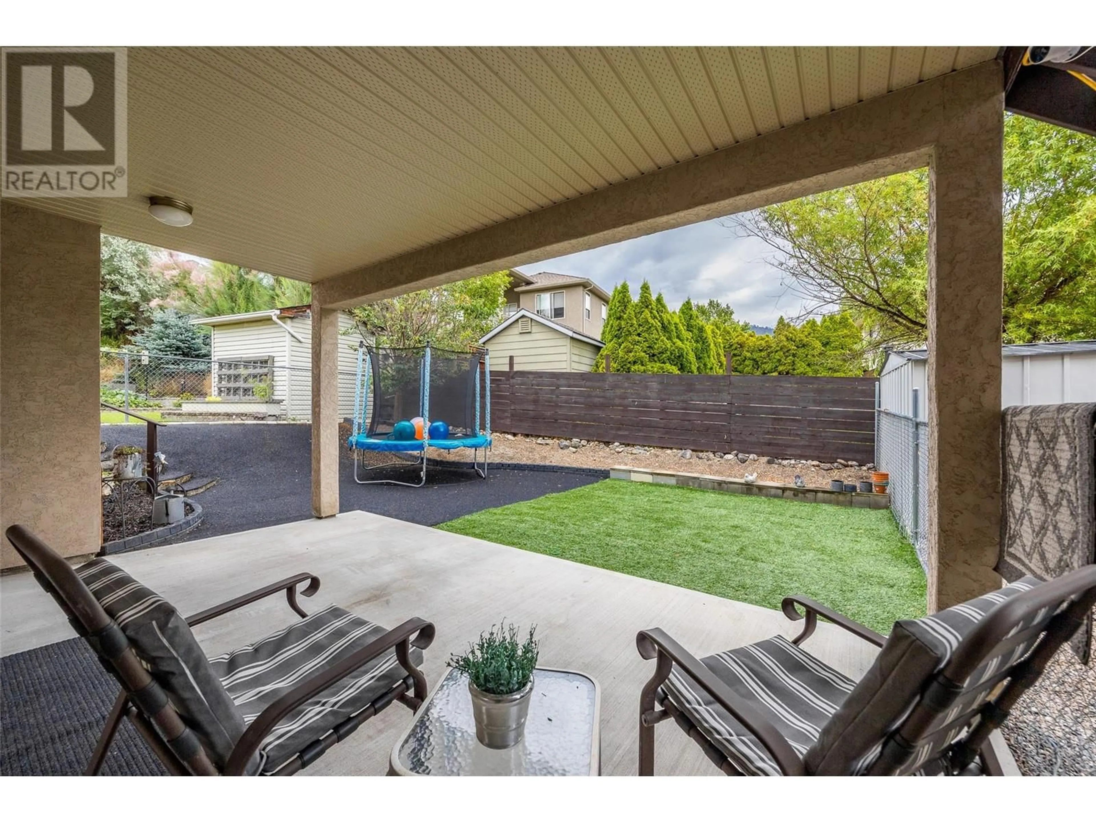 Patio, the fenced backyard for 1503 Tanemura Crescent, Kelowna British Columbia V1P1N8