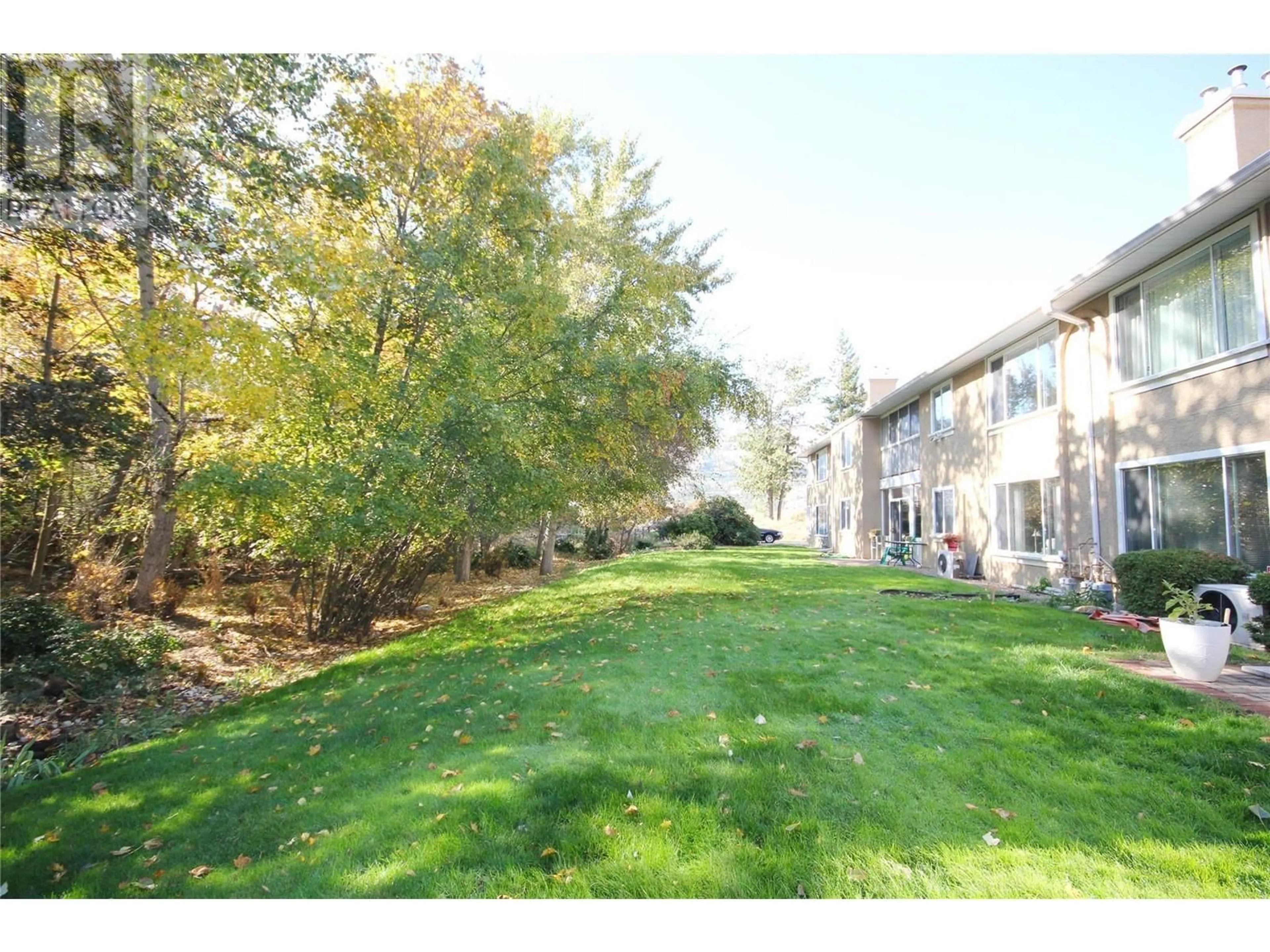 A pic from exterior of the house or condo, the fenced backyard for 320 BRANDON Avenue Unit# 107, Penticton British Columbia V2A3S8