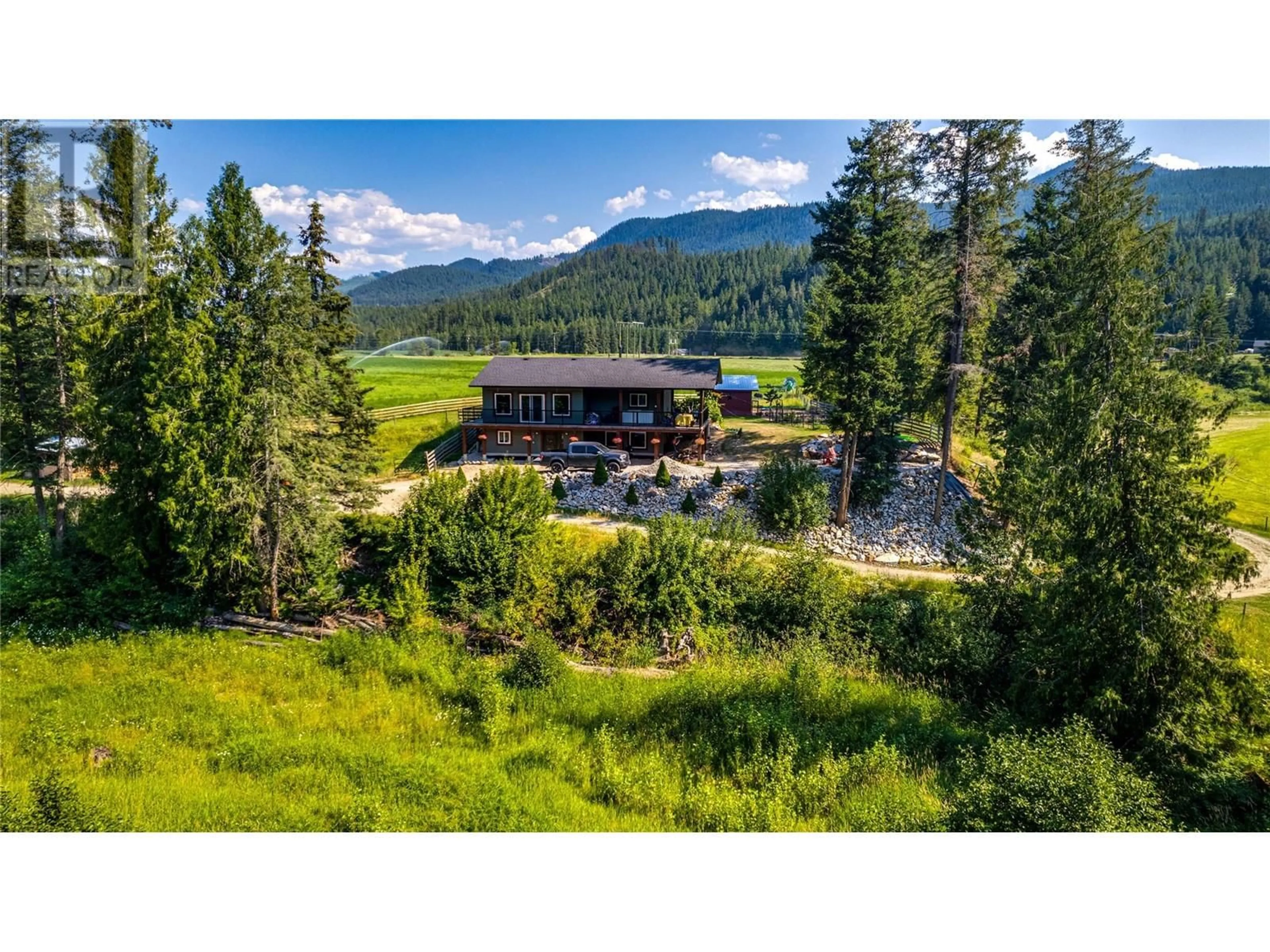 A pic from outside/outdoor area/front of a property/back of a property/a pic from drone, mountain view for 1519 6 HIGHWAY, Cherryville British Columbia V0E2G1