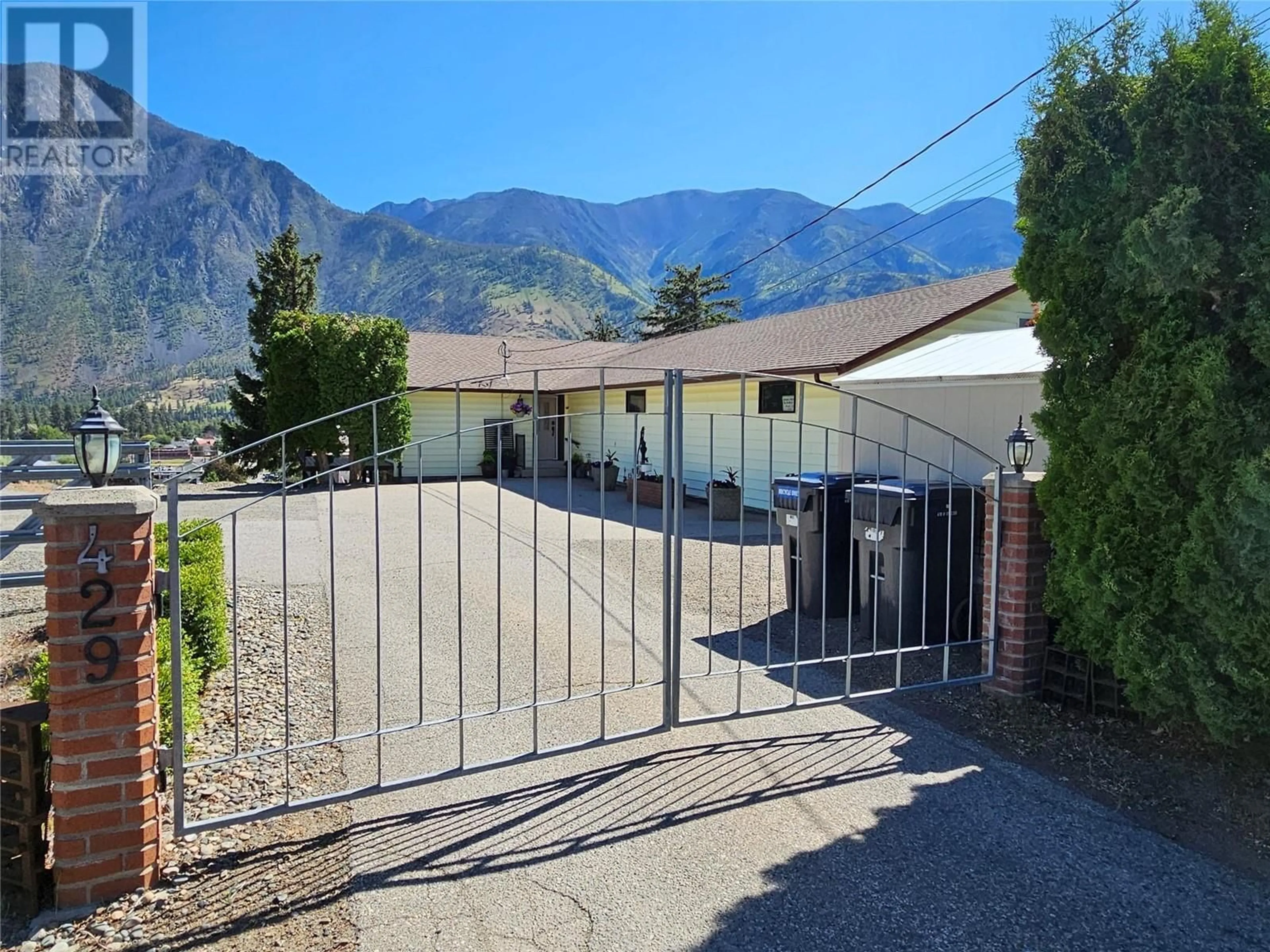 Frontside or backside of a home, the fenced backyard for 429 3rd Avenue, Keremeos British Columbia V0X1N2