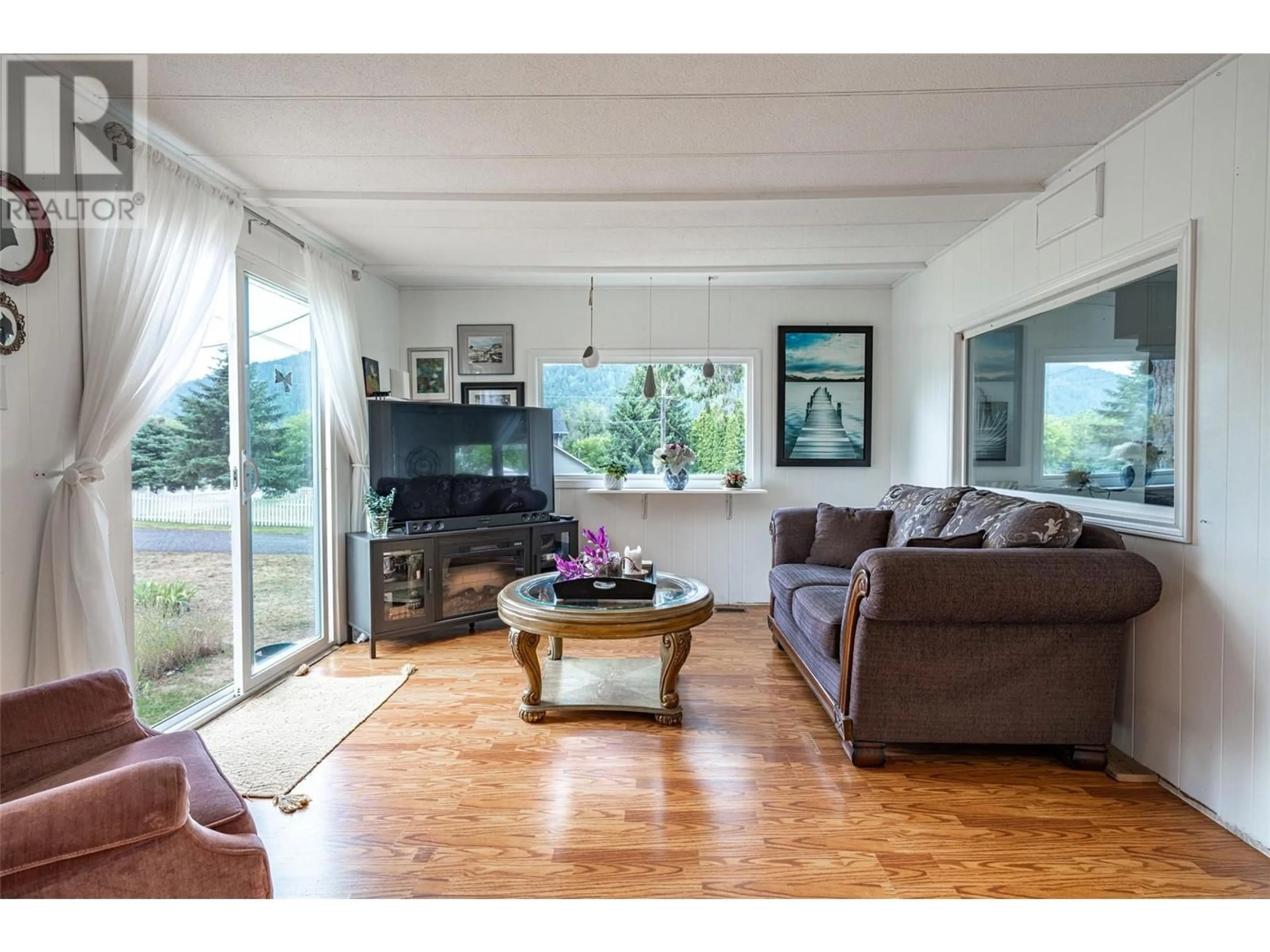 Living room with furniture, wood/laminate floor for 5664 Ponderosa Road, Falkland British Columbia V0E1W0