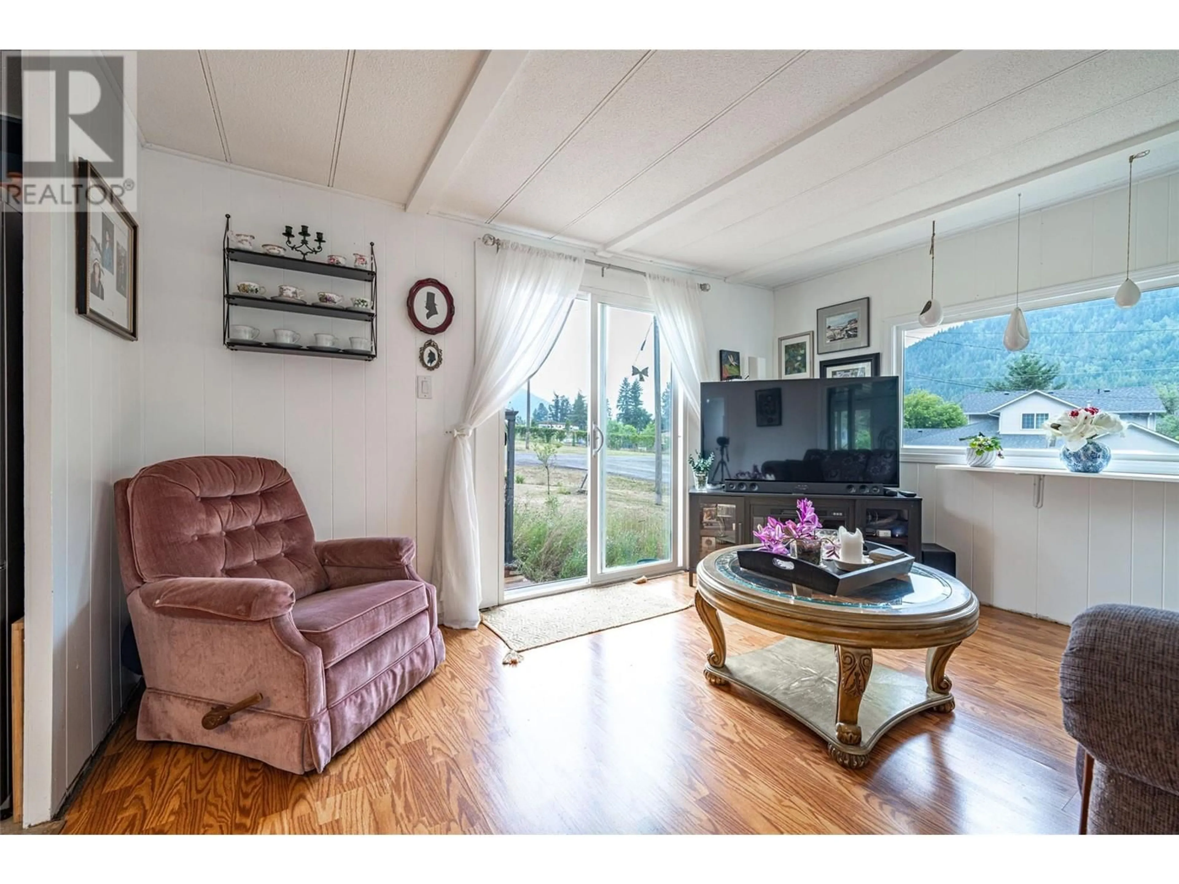 Living room with furniture, wood/laminate floor for 5664 Ponderosa Road, Falkland British Columbia V0E1W0