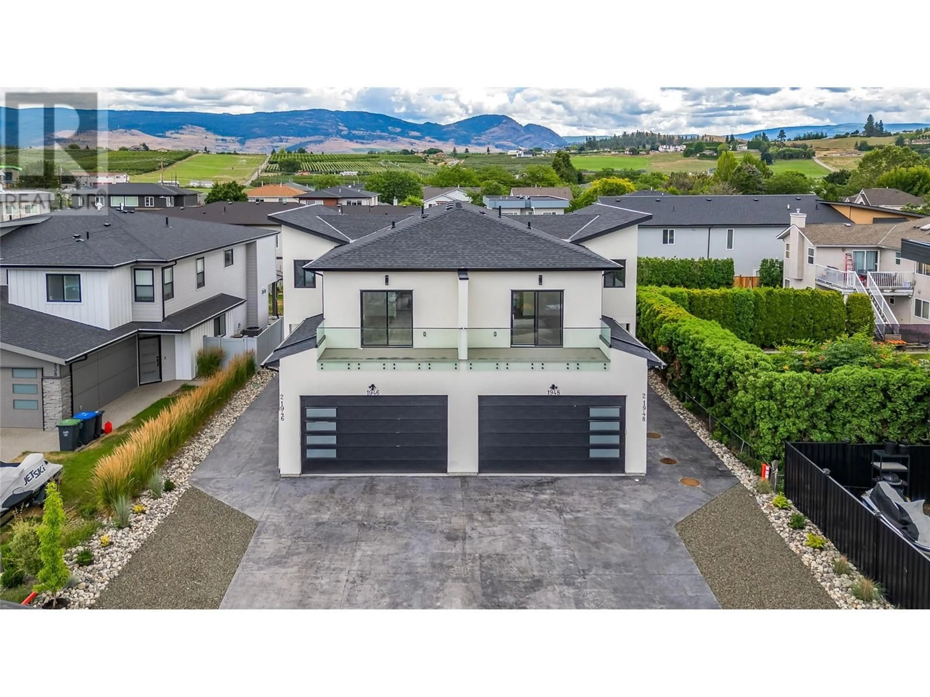 A pic from outside/outdoor area/front of a property/back of a property/a pic from drone, mountain view for 1948 HEMMERLING COURT, Kelowna British Columbia V1V1X1