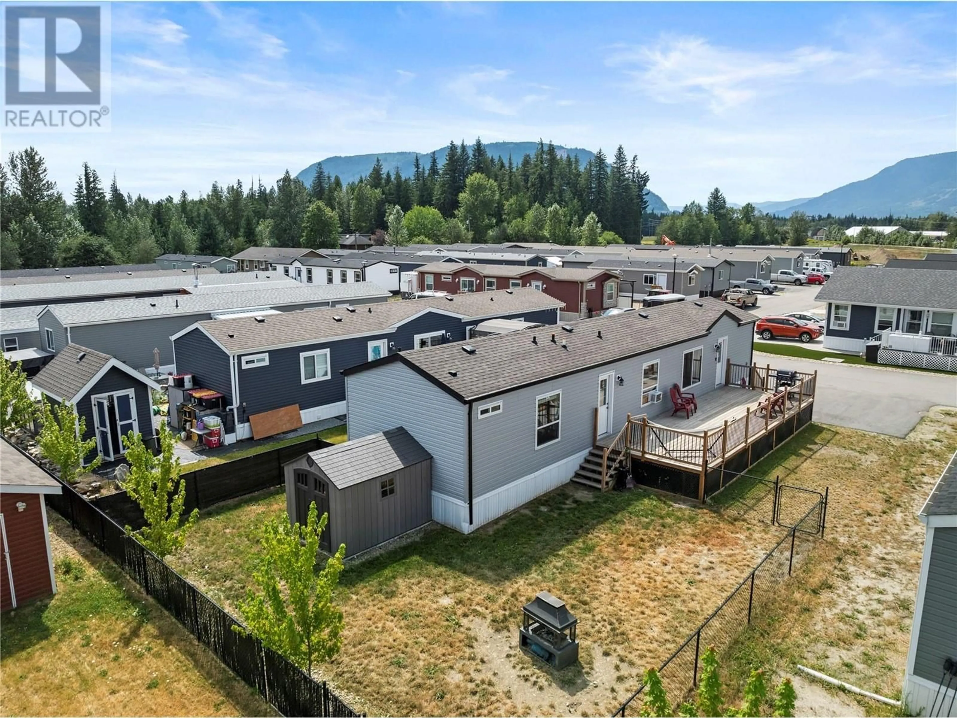 Frontside or backside of a home, the fenced backyard for 1705 Hillier Road E Unit# 2, Sicamous British Columbia V0E2V4