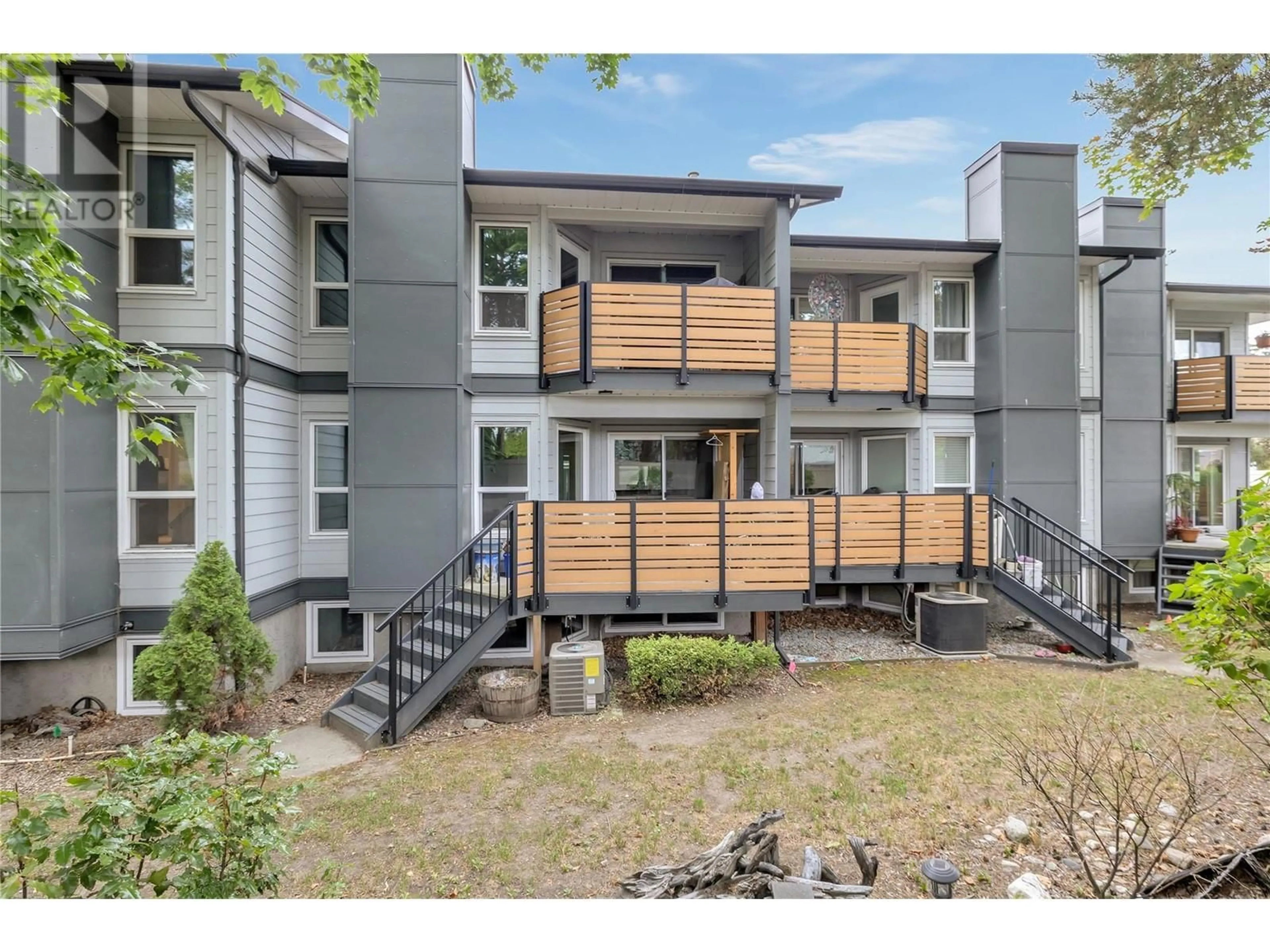 A pic from exterior of the house or condo, the fenced backyard for 2125 Burtch Road Unit# 103, Kelowna British Columbia V1Y7Z5