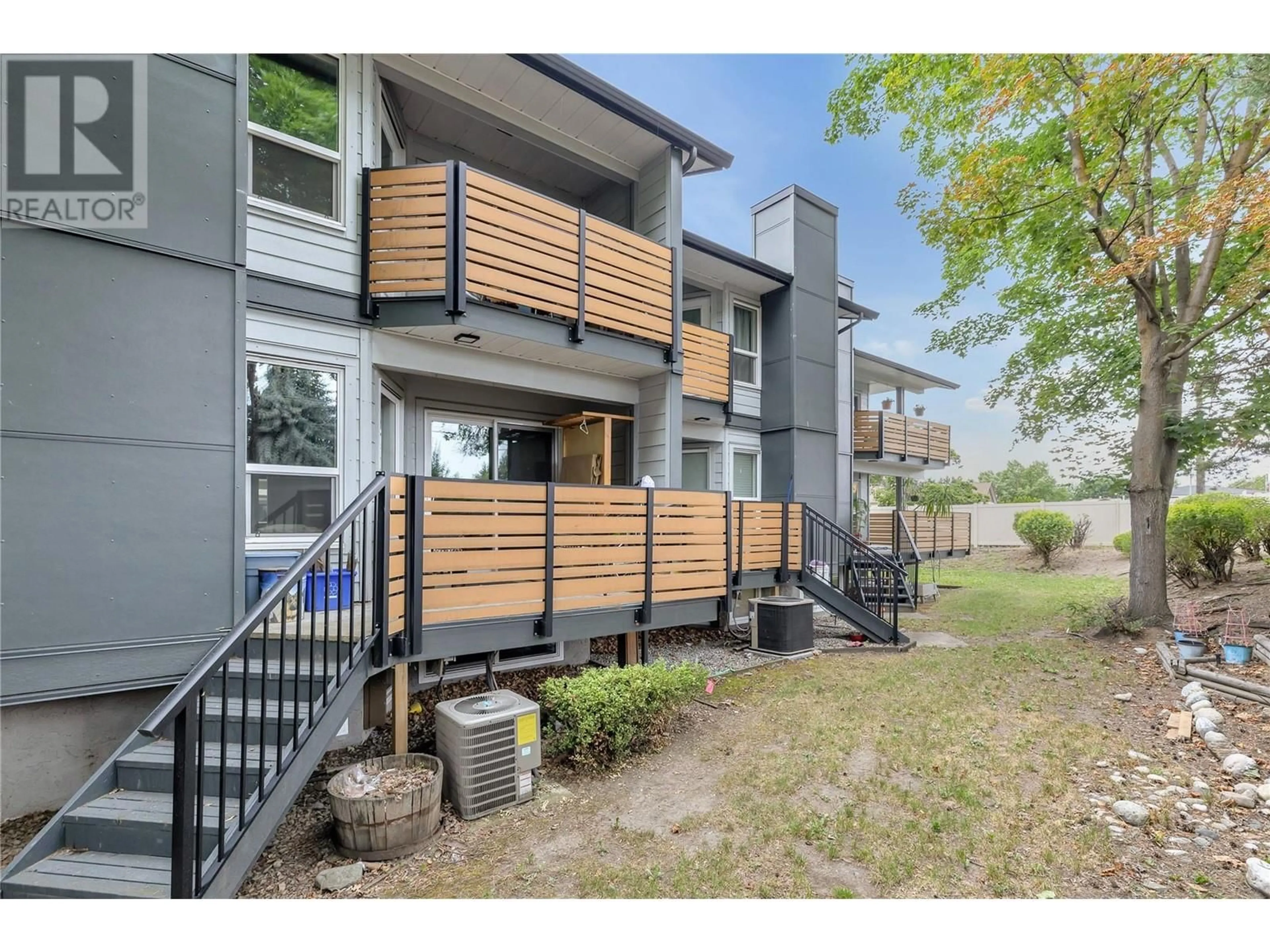 A pic from exterior of the house or condo, the fenced backyard for 2125 Burtch Road Unit# 103, Kelowna British Columbia V1Y7Z5