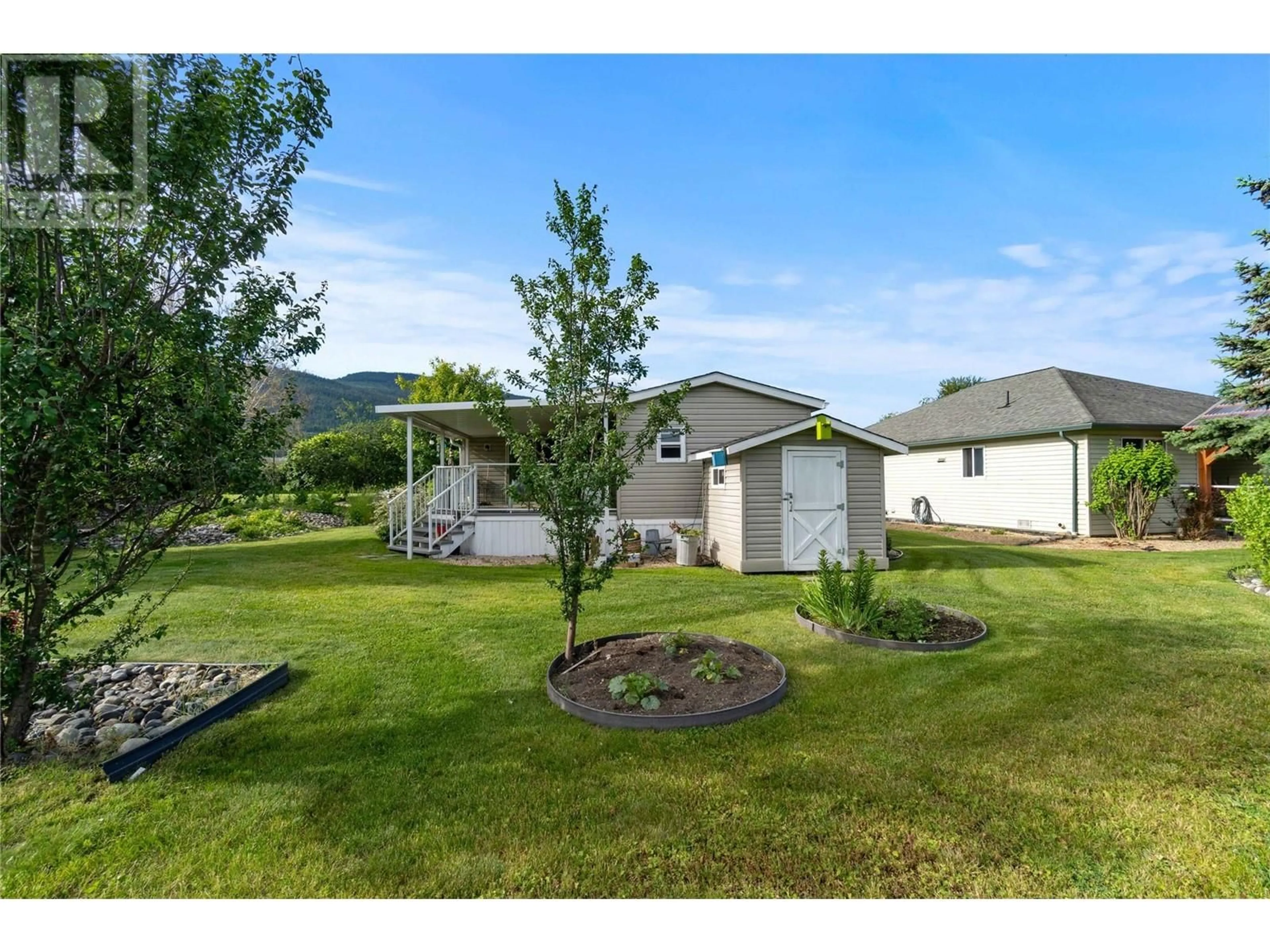 Frontside or backside of a home, the fenced backyard for 601 Beatty Avenue NW Unit# 5, Salmon Arm British Columbia V1E3J6