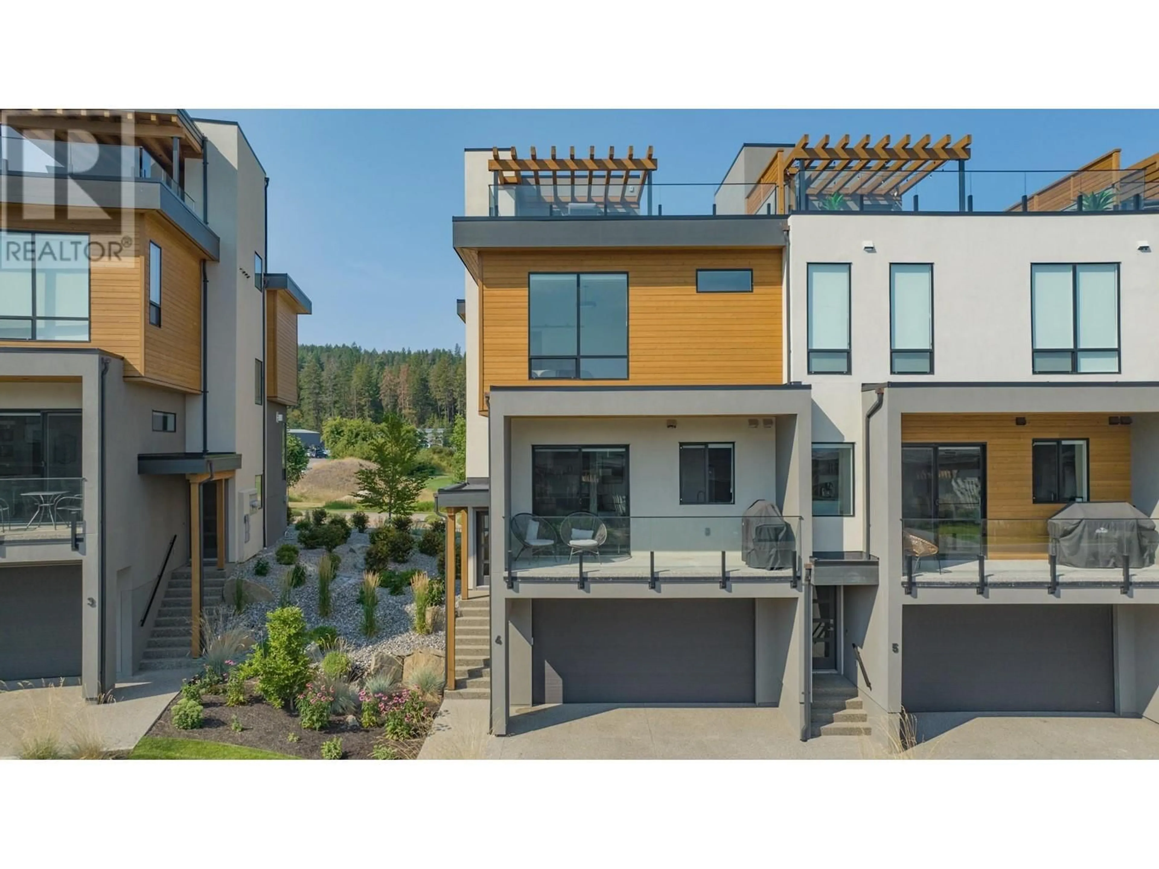 A pic from outside/outdoor area/front of a property/back of a property/a pic from drone, street for 4 - 105 PREDATOR RIDGE DRIVE, Vernon British Columbia V1H0A5