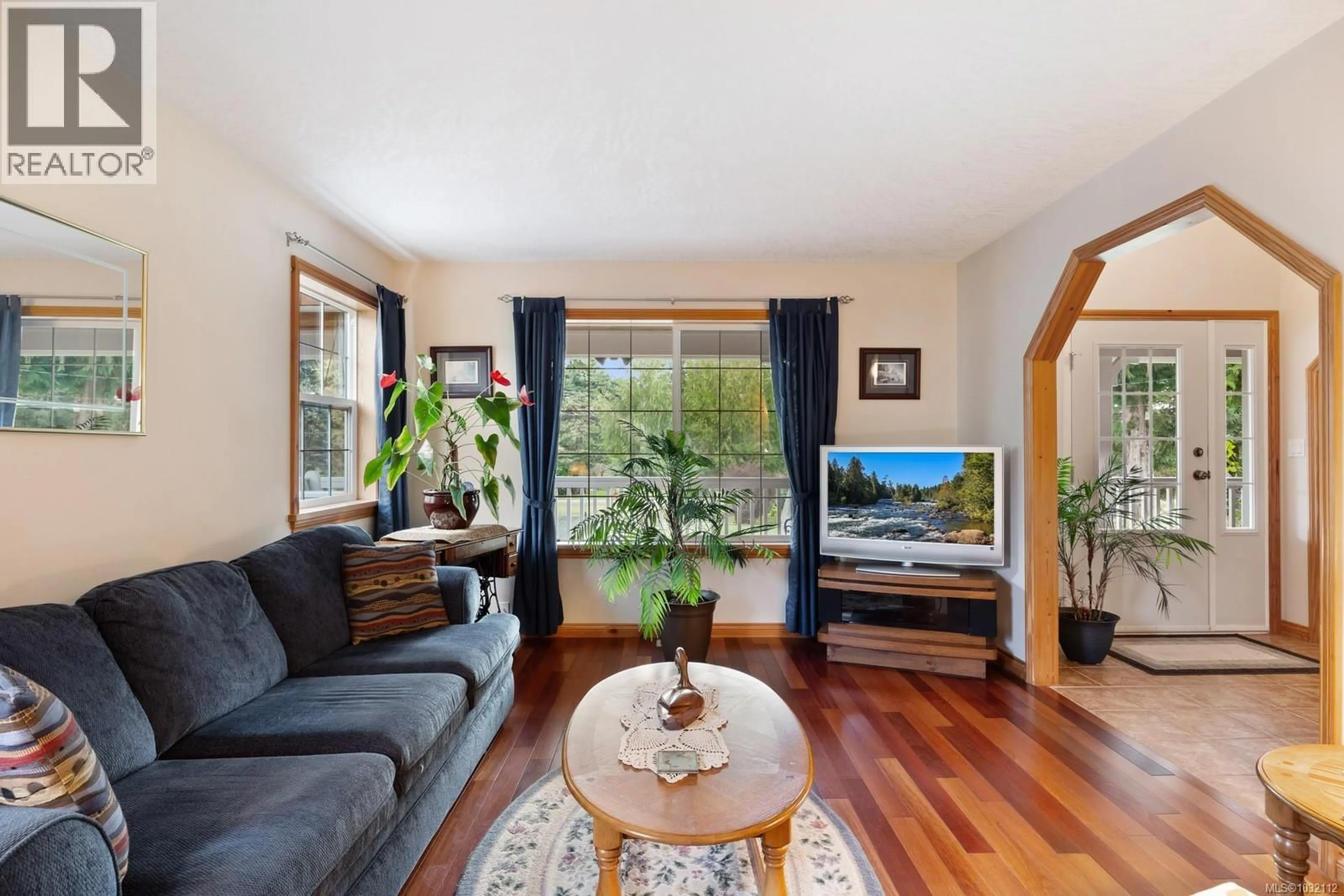 Living room with furniture, wood/laminate floor for 1535 BAIKIE ROAD, Denman Island British Columbia V0R1T0