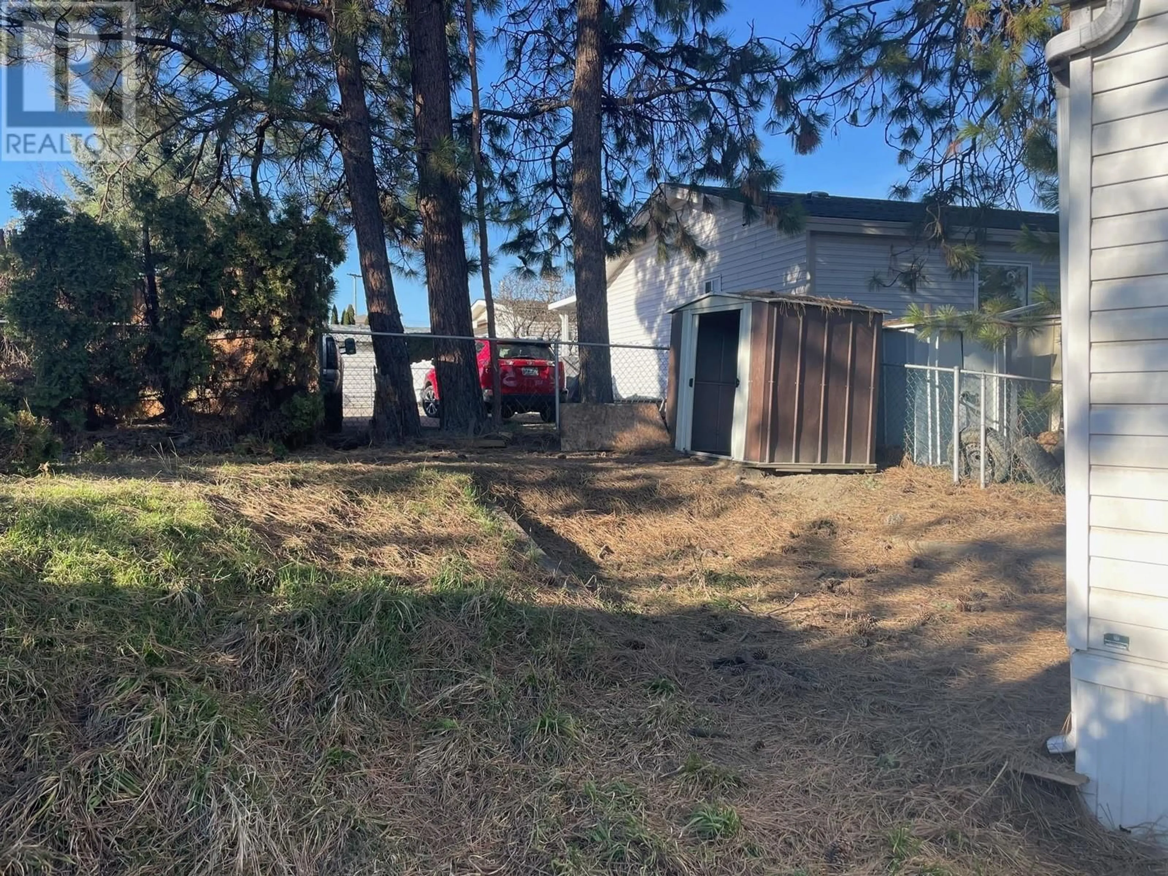 Frontside or backside of a home, the fenced backyard for 1940 Nancee Way Unit# 3, West Kelowna British Columbia V1Z3R5