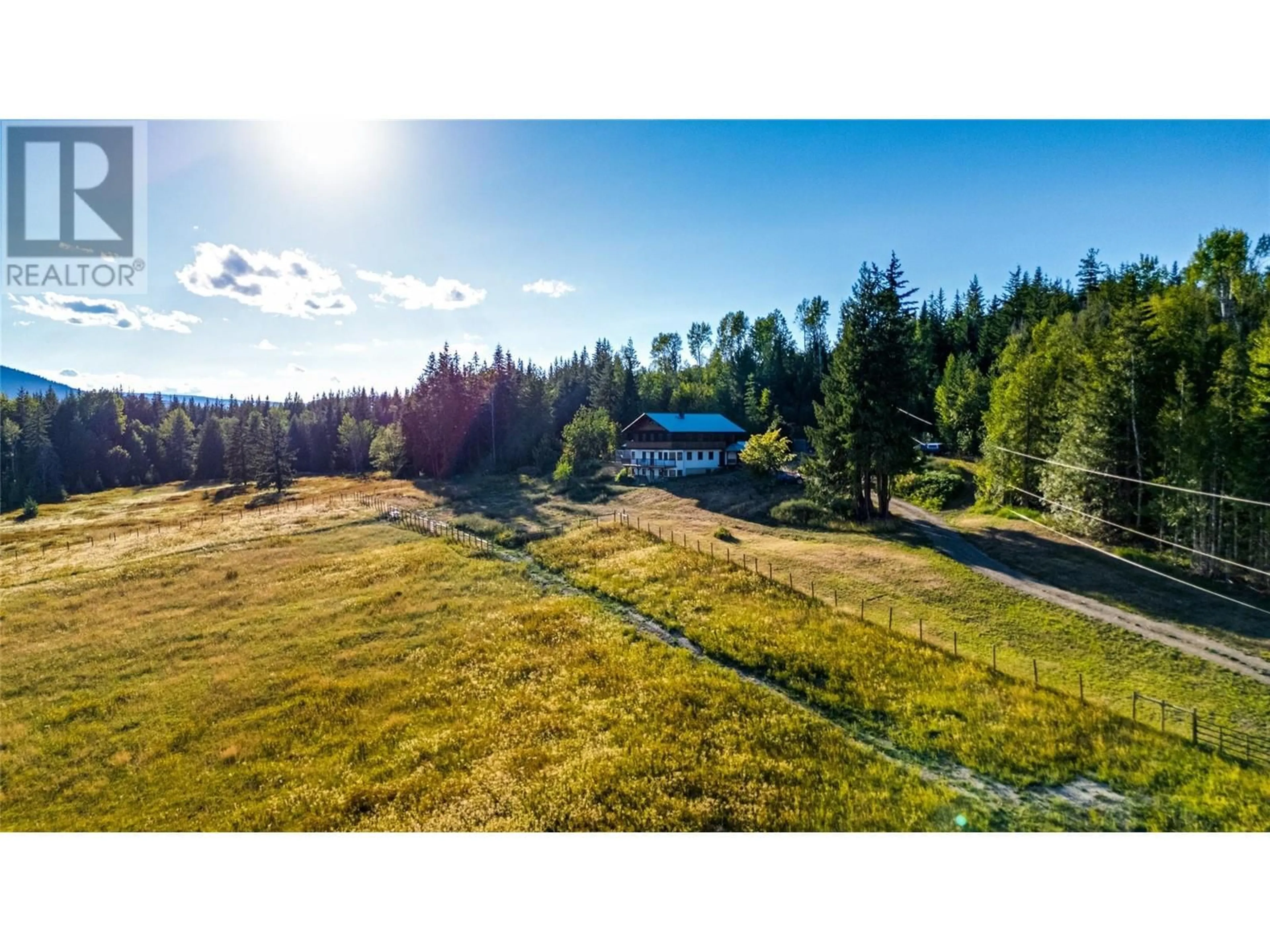 A pic from exterior of the house or condo, the fenced backyard for 100 Lidstone Road, Grindrod British Columbia V1E4P9