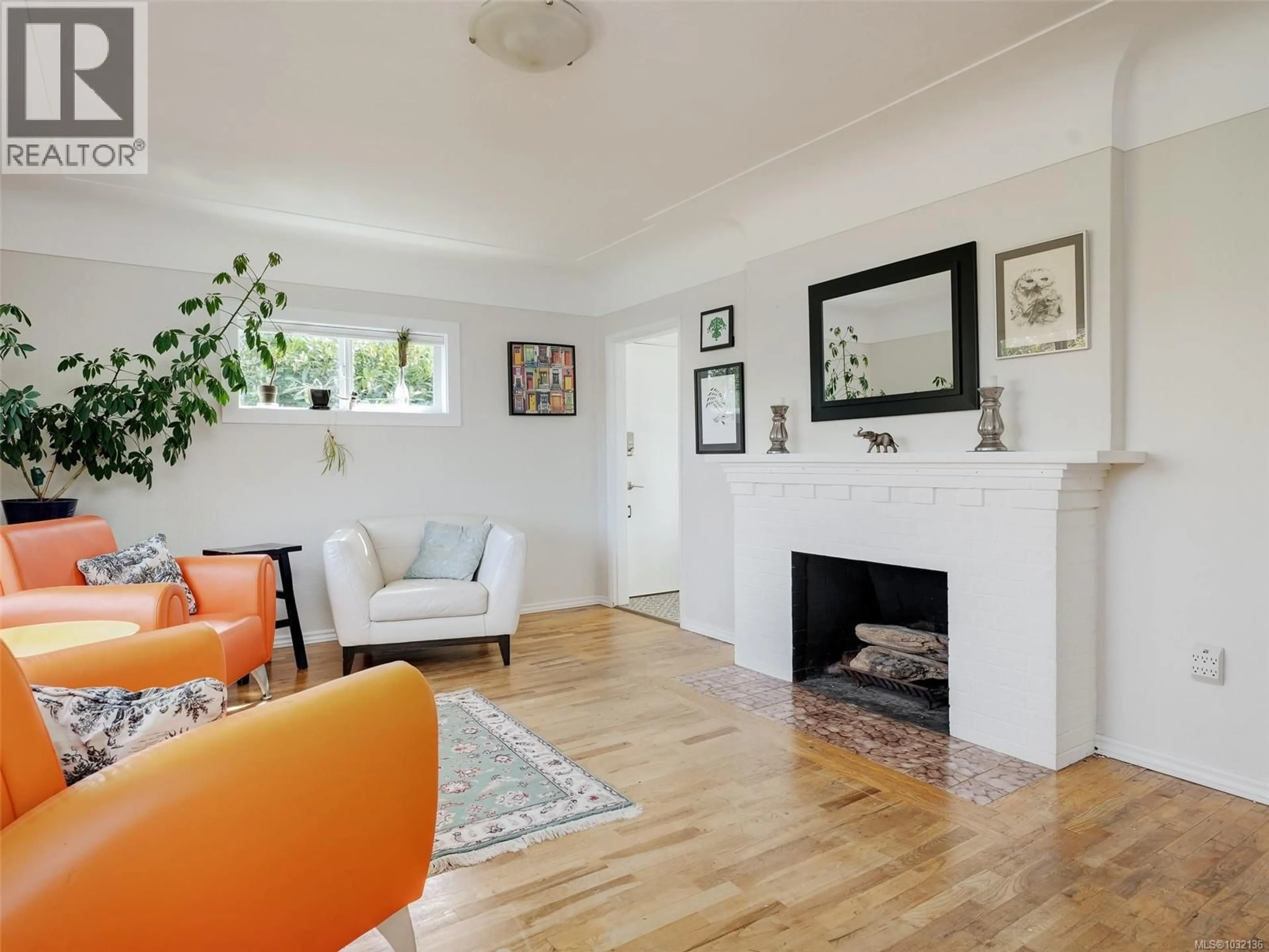 Living room with furniture, wood/laminate floor for 2430 FOUL BAY ROAD, Saanich British Columbia V8R5A9