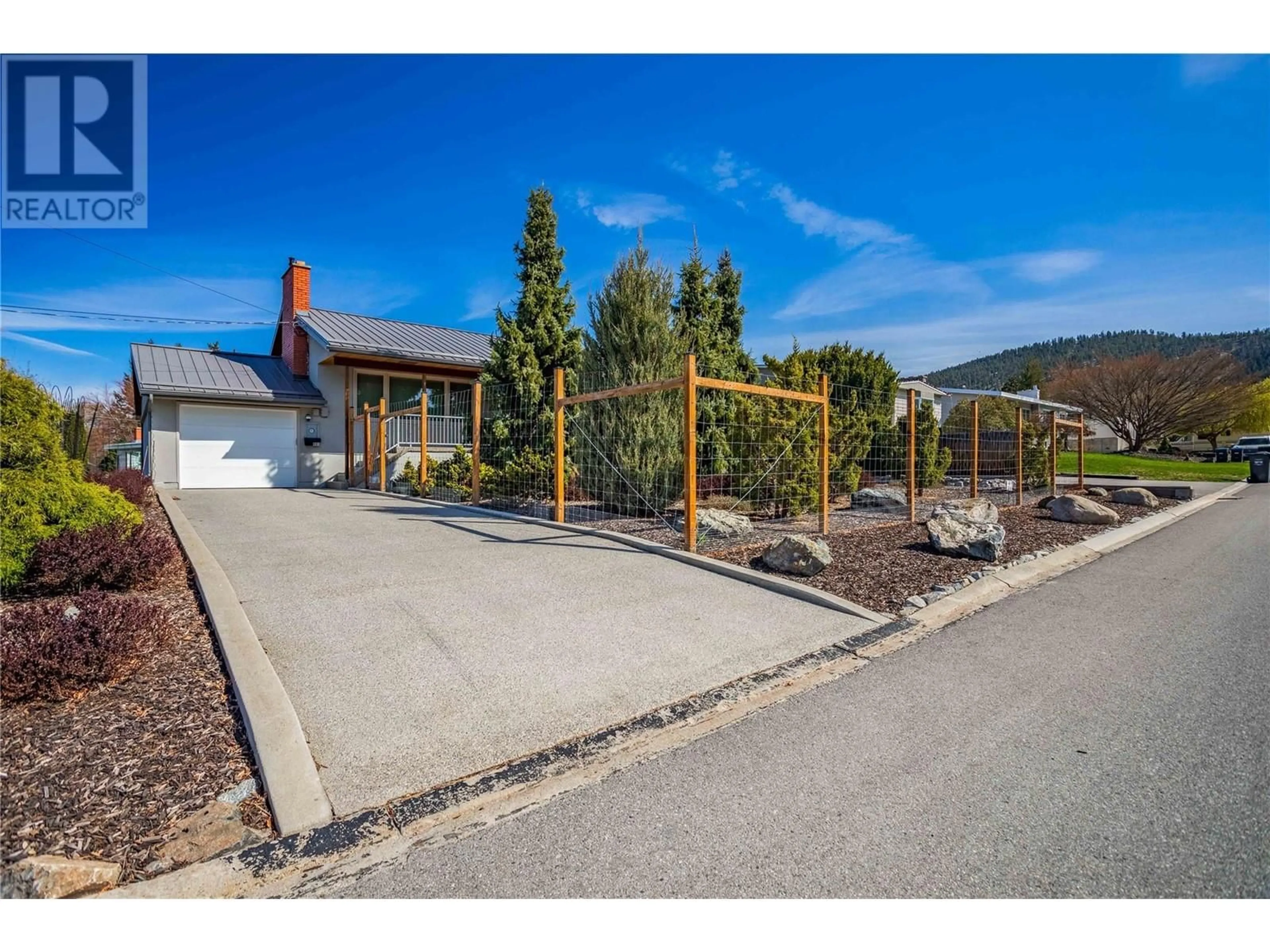 Frontside or backside of a home, the fenced backyard for 901 Barrington Avenue, Penticton British Columbia V2A1S2