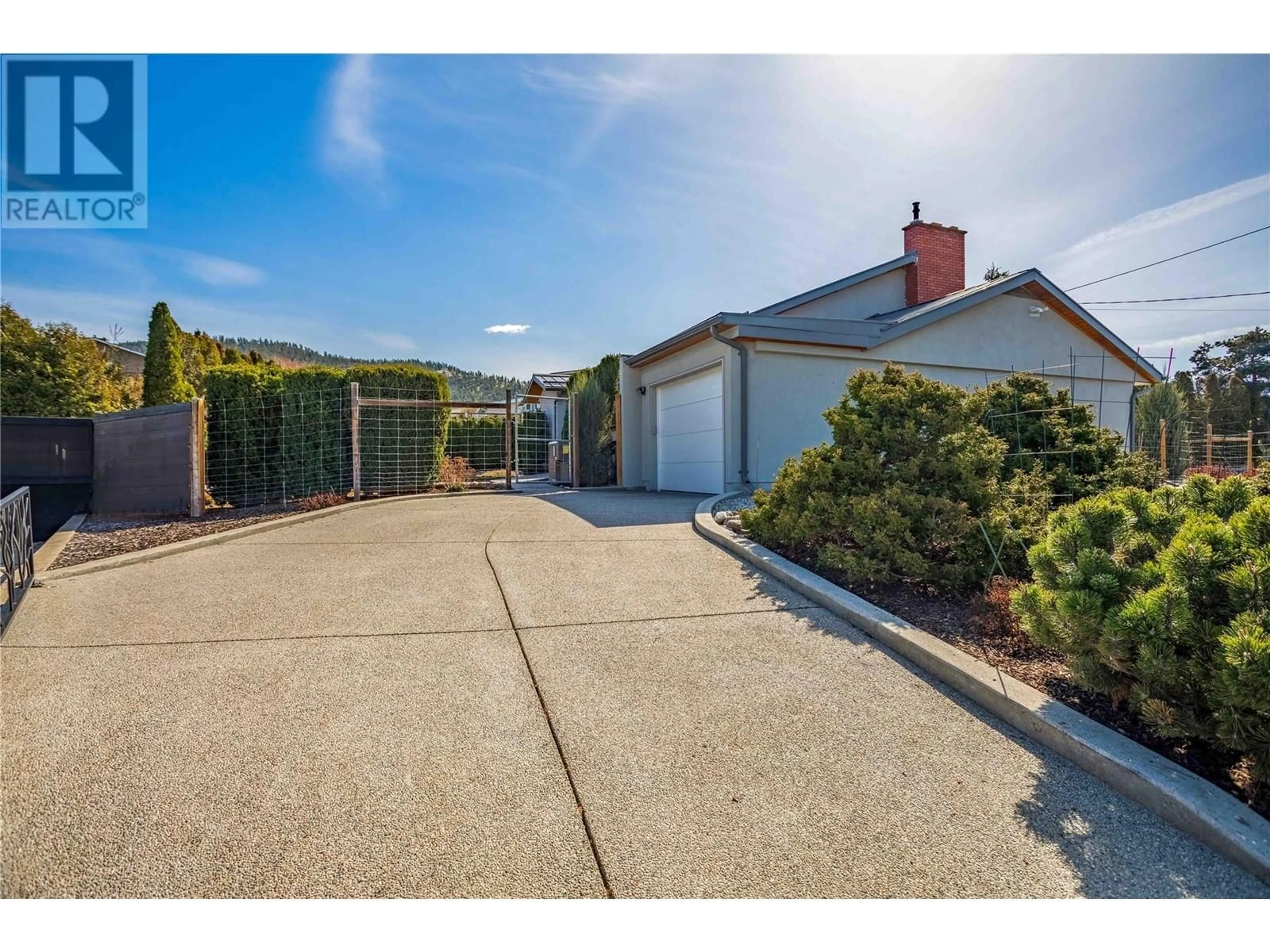 Frontside or backside of a home, the fenced backyard for 901 Barrington Avenue, Penticton British Columbia V2A1S2