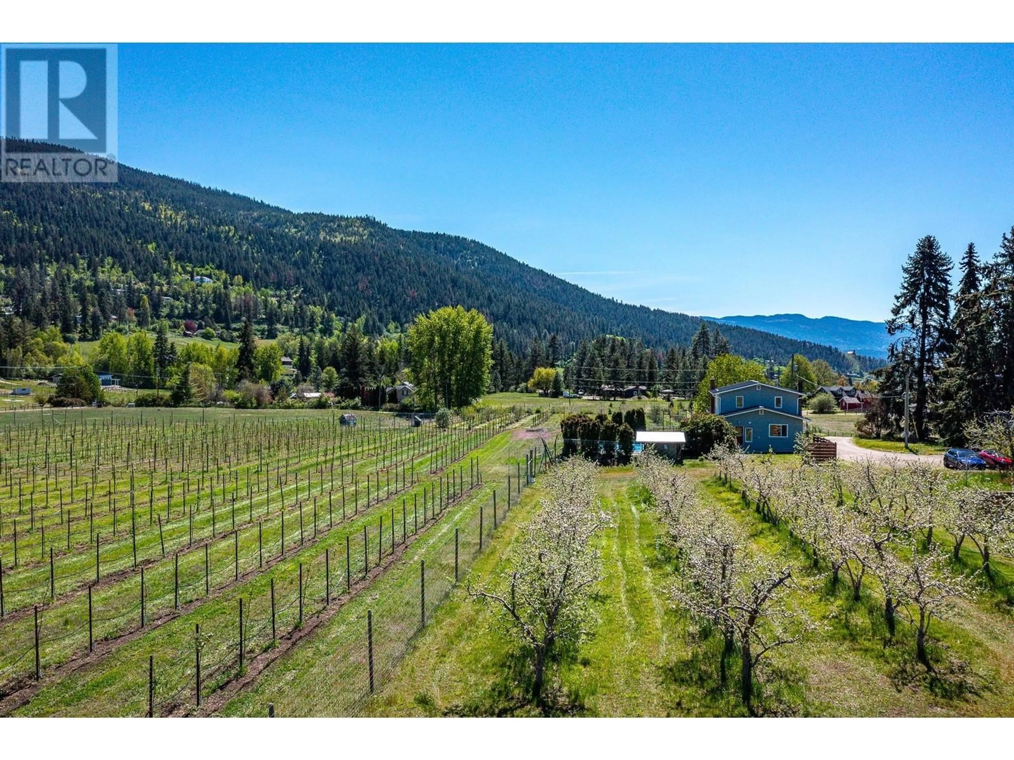 A pic from exterior of the house or condo, the fenced backyard for 5657 Malim Road, Vernon British Columbia V1B3J8