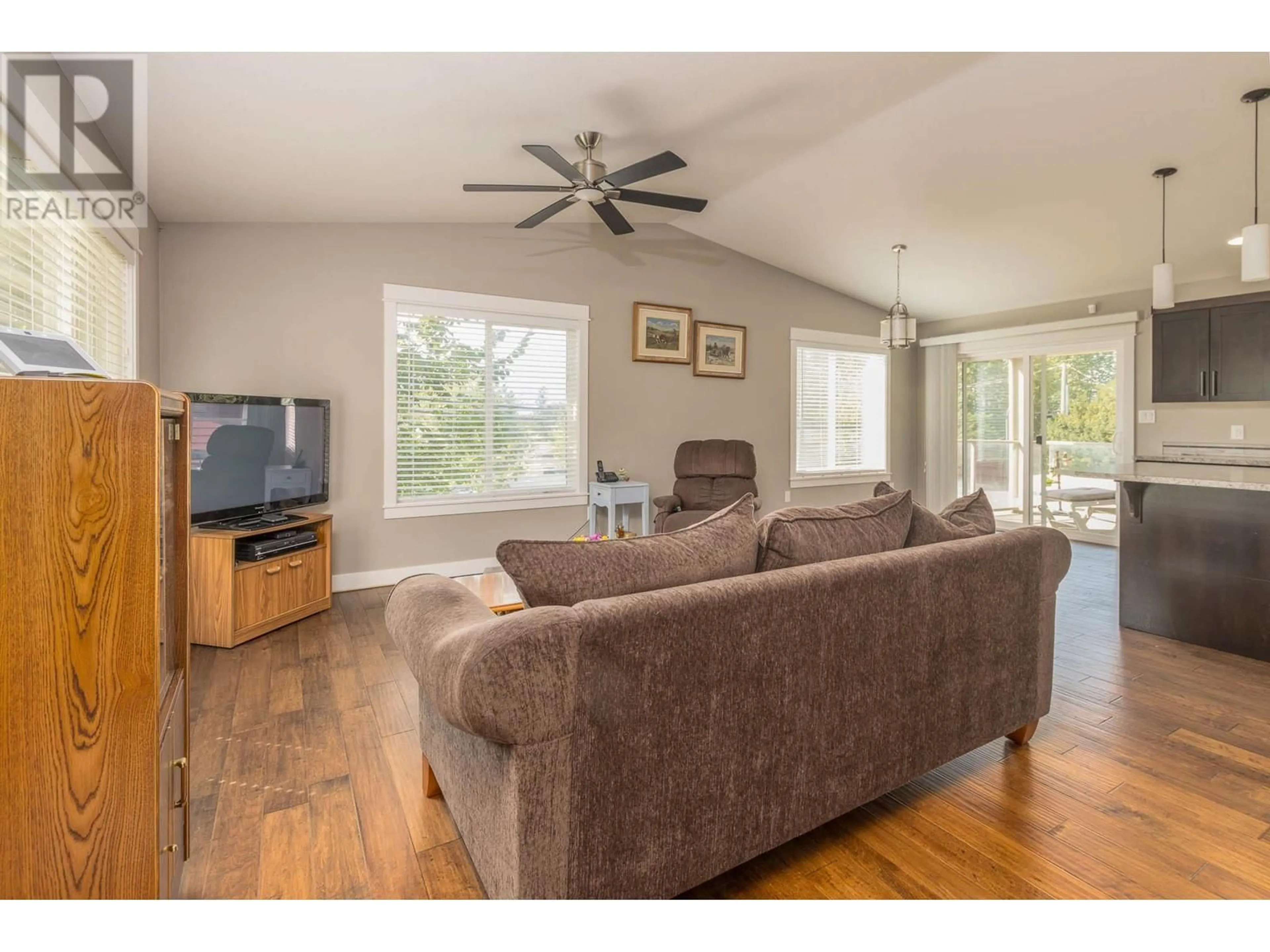 Living room with furniture, wood/laminate floor for 2021 1 Avenue NE, Salmon Arm British Columbia V1E1Z5