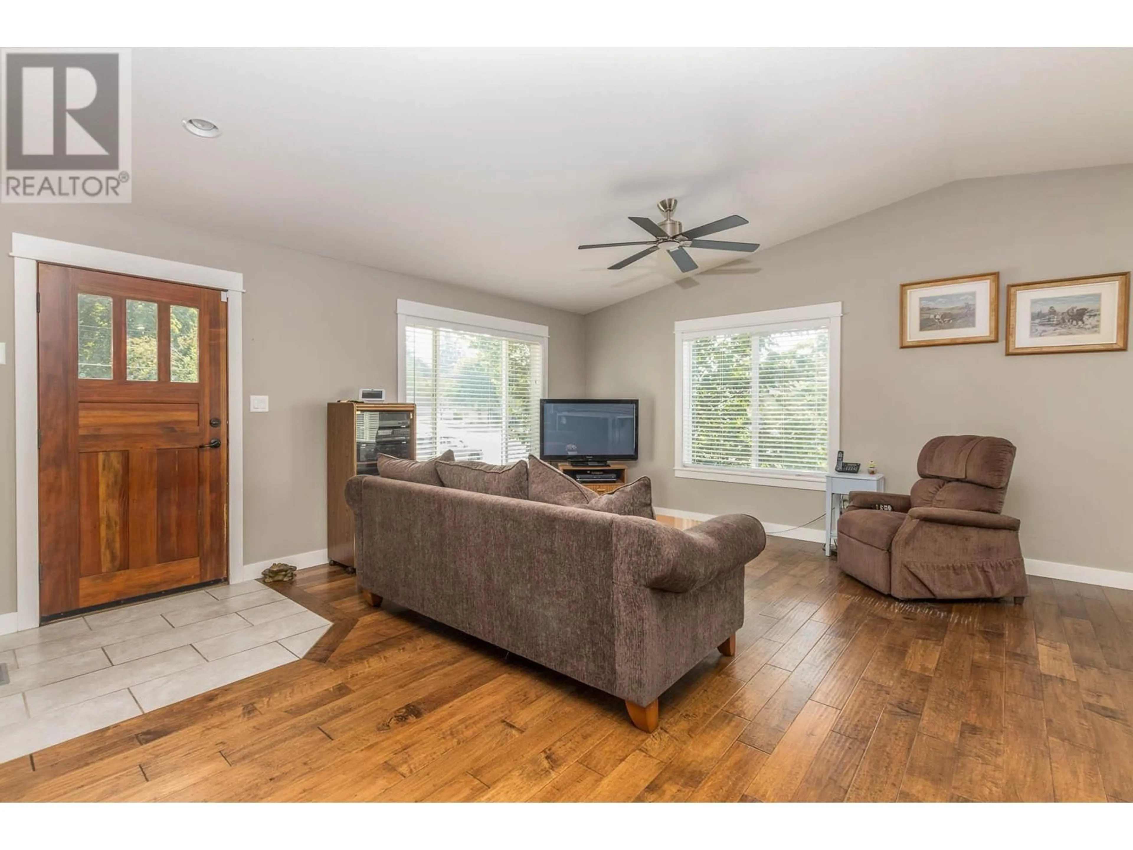 Living room with furniture, wood/laminate floor for 2021 1 Avenue NE, Salmon Arm British Columbia V1E1Z5