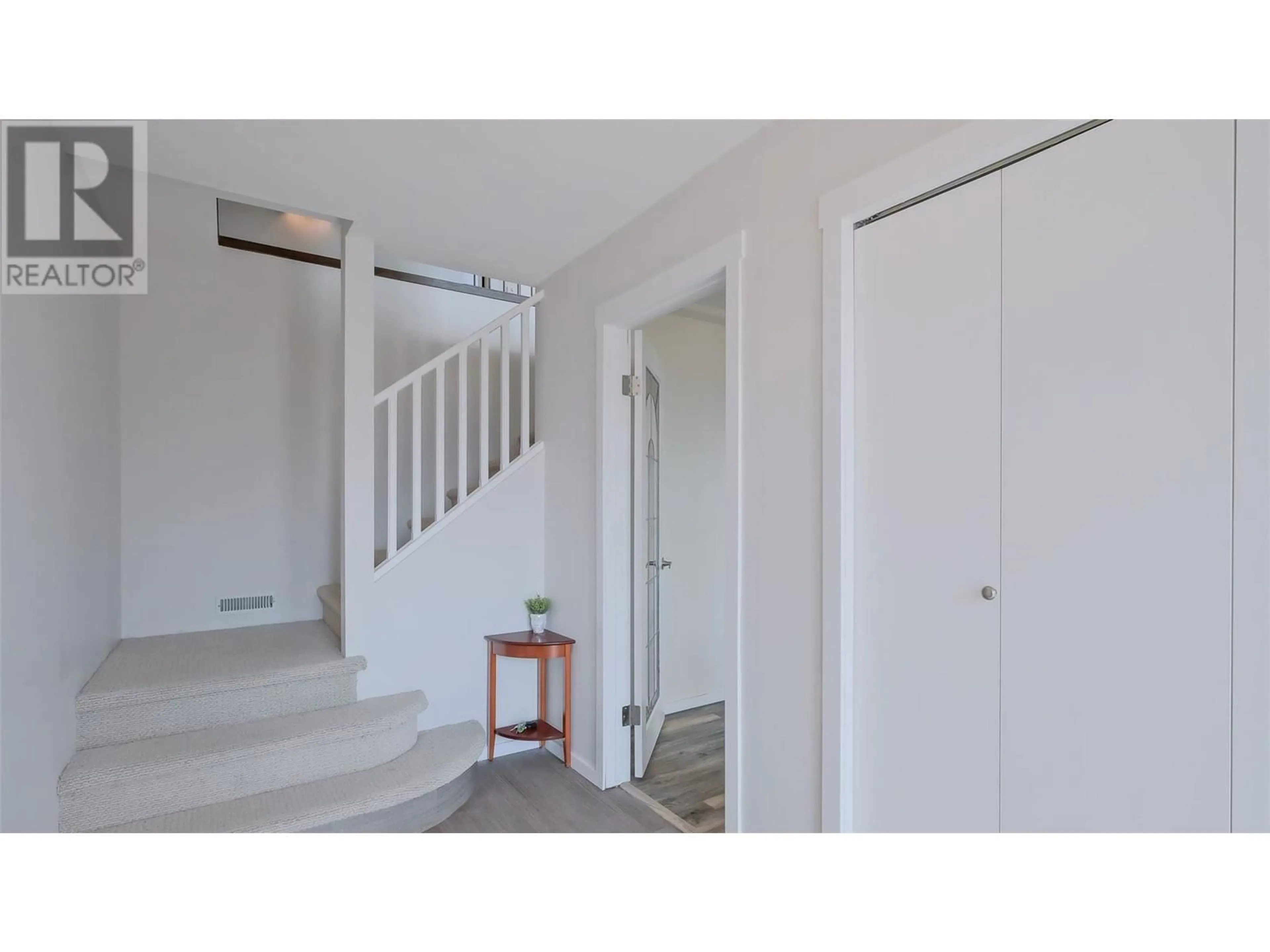 Indoor foyer, wood floors for 1556 Blackwood Drive, Kelowna British Columbia V1Z3B7