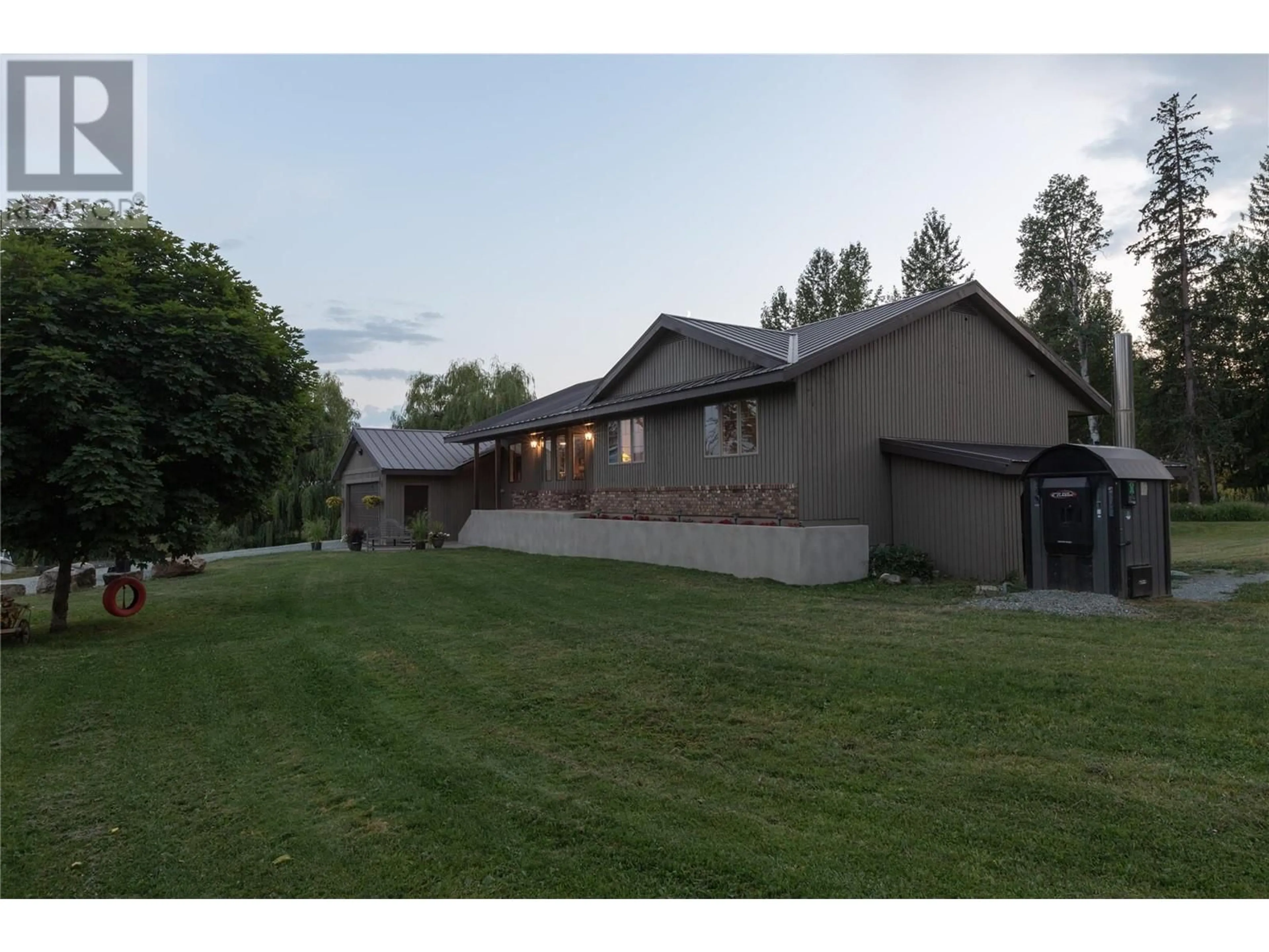 Frontside or backside of a home, the fenced backyard for 2523 Evans Road, Celista British Columbia V0E1M6