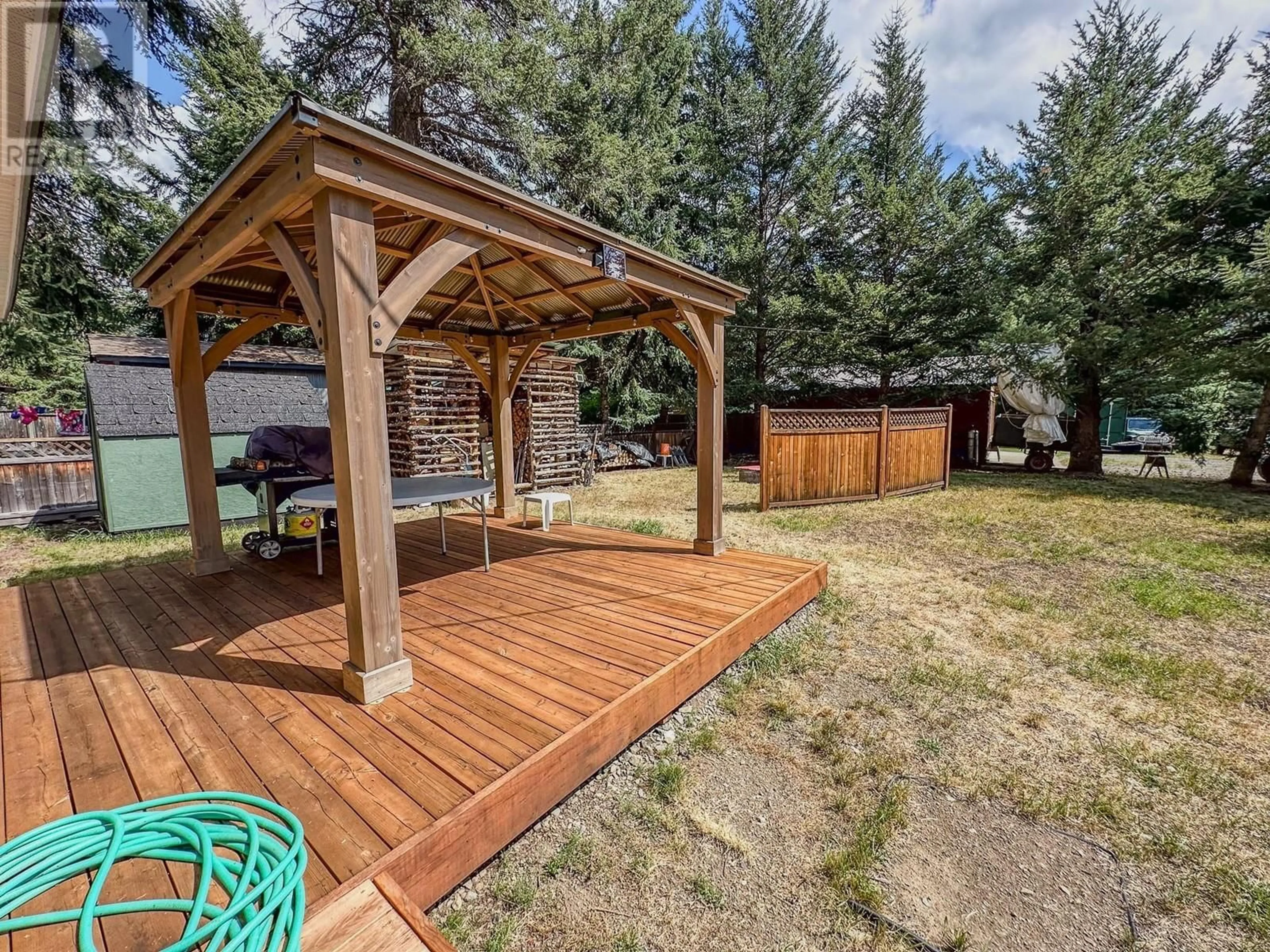 Patio, the fenced backyard for 125 Missezula Lake Road, Princeton British Columbia V0X1W0