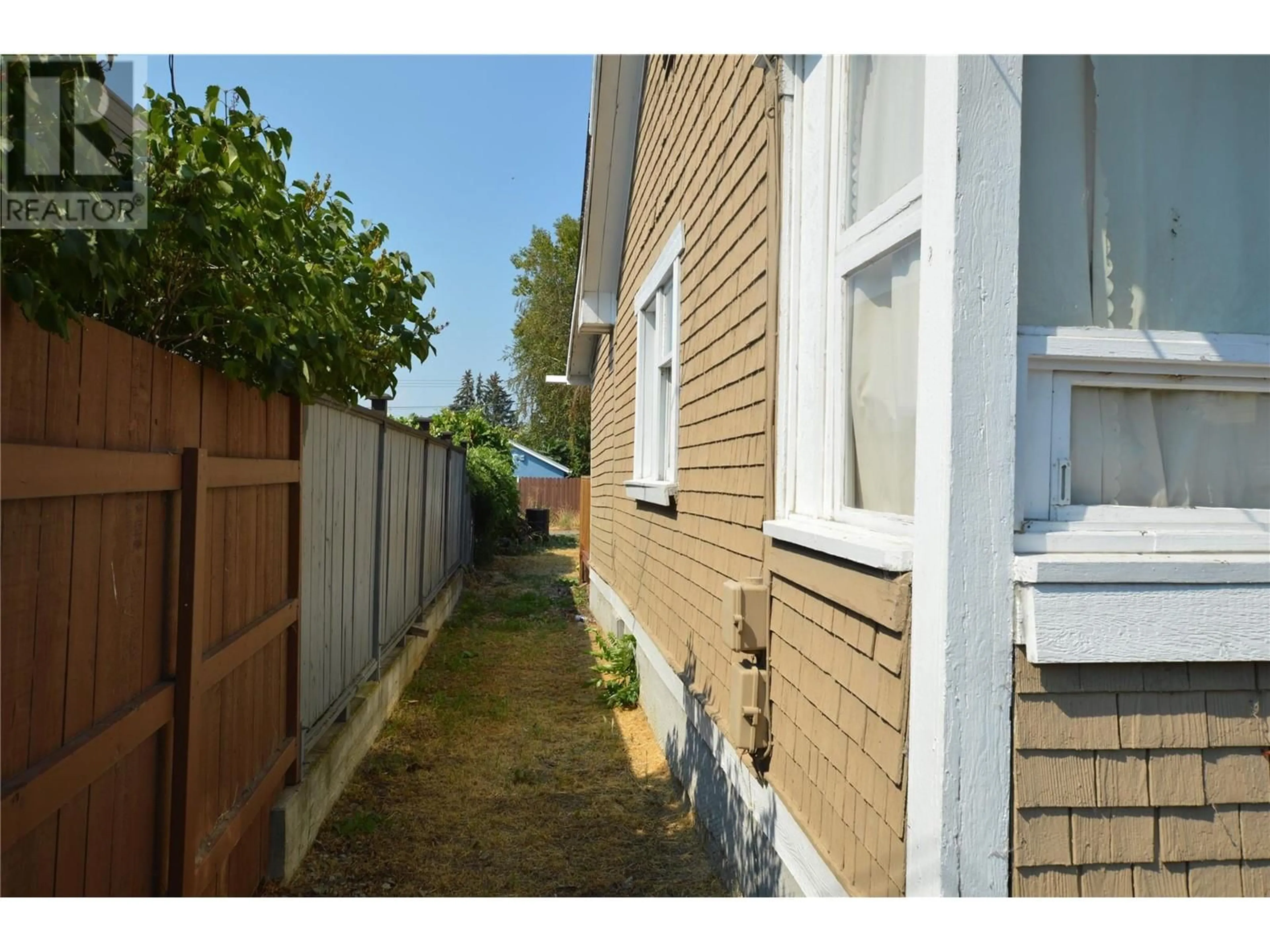 Frontside or backside of a home, the fenced backyard for 499 Westminster Avenue W, Penticton British Columbia V2A1K4