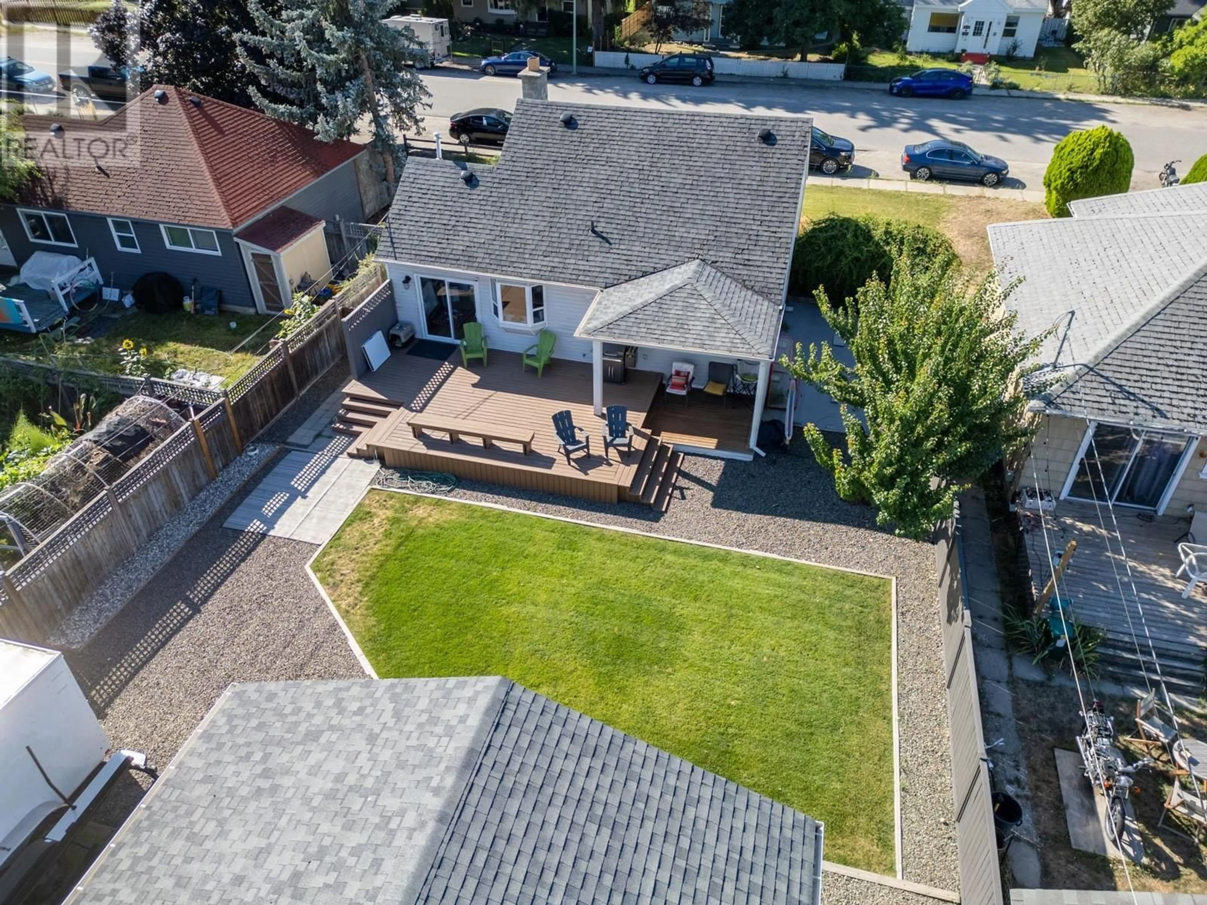 Frontside or backside of a home, the fenced backyard for 566 Okanagan Boulevard, Kelowna British Columbia V1Y7L1