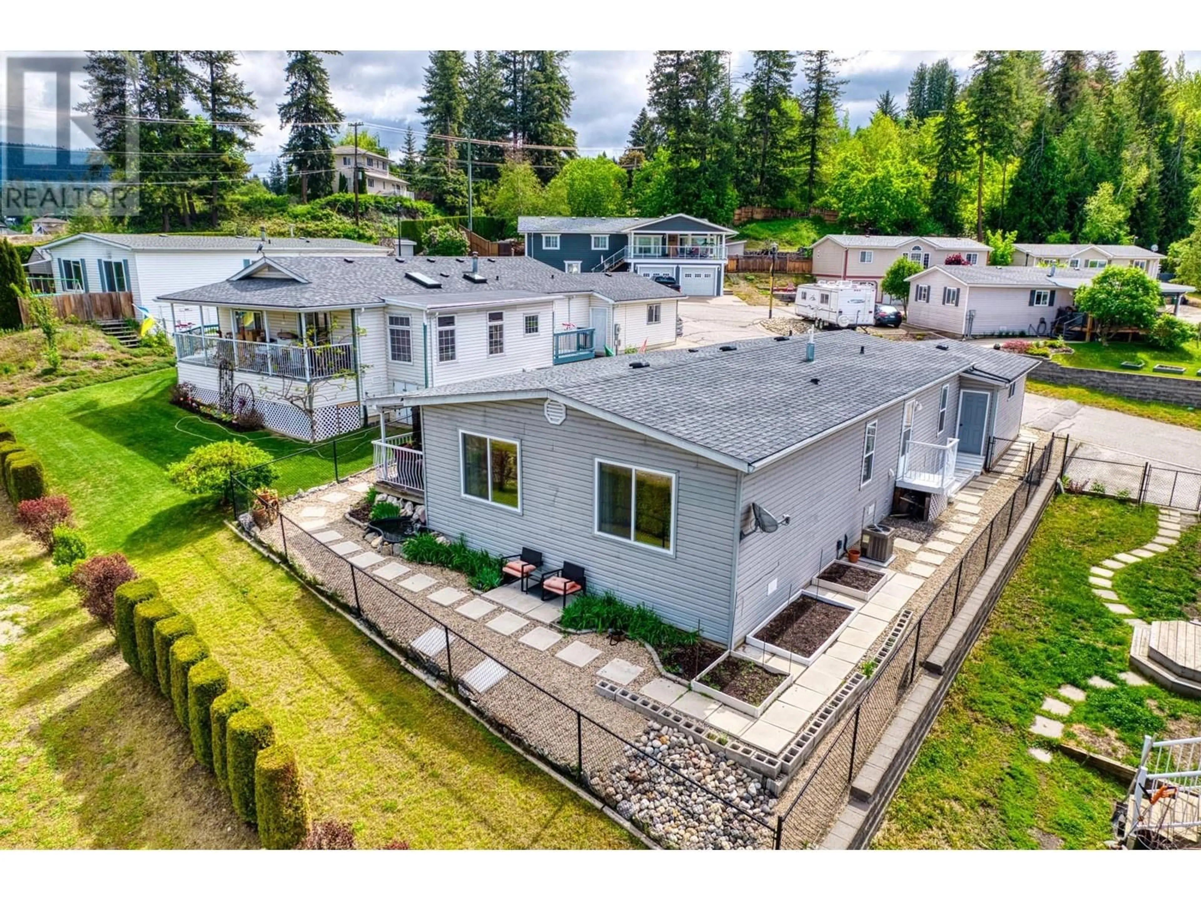 Frontside or backside of a home, the fenced backyard for 900 10 Avenue SE Unit# 7, Salmon Arm British Columbia V1E2W6