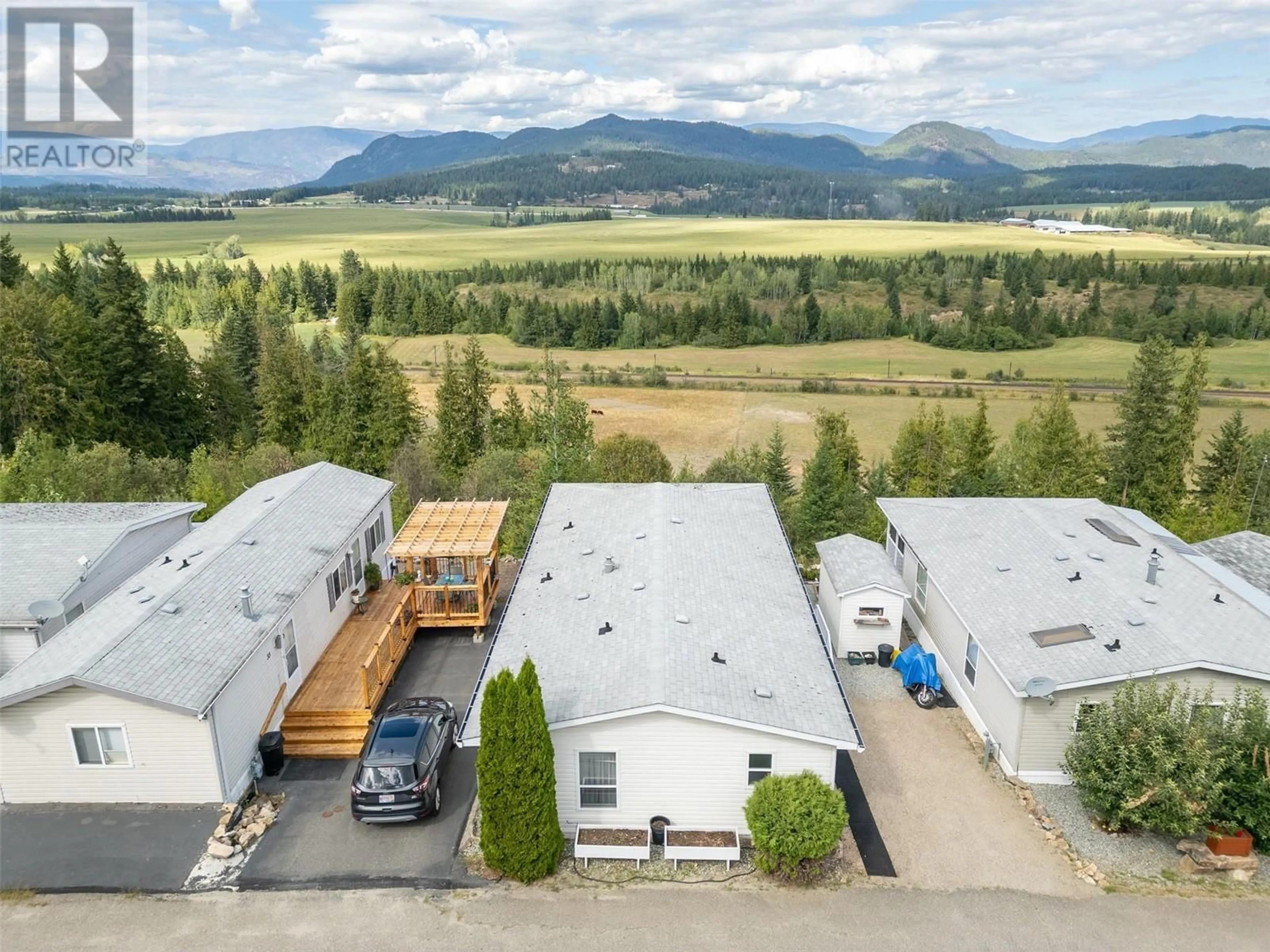 A pic from exterior of the house or condo, the fenced backyard for 1885 Tappen Notch Hill Road Unit# 32, Tappen British Columbia V0E2X3