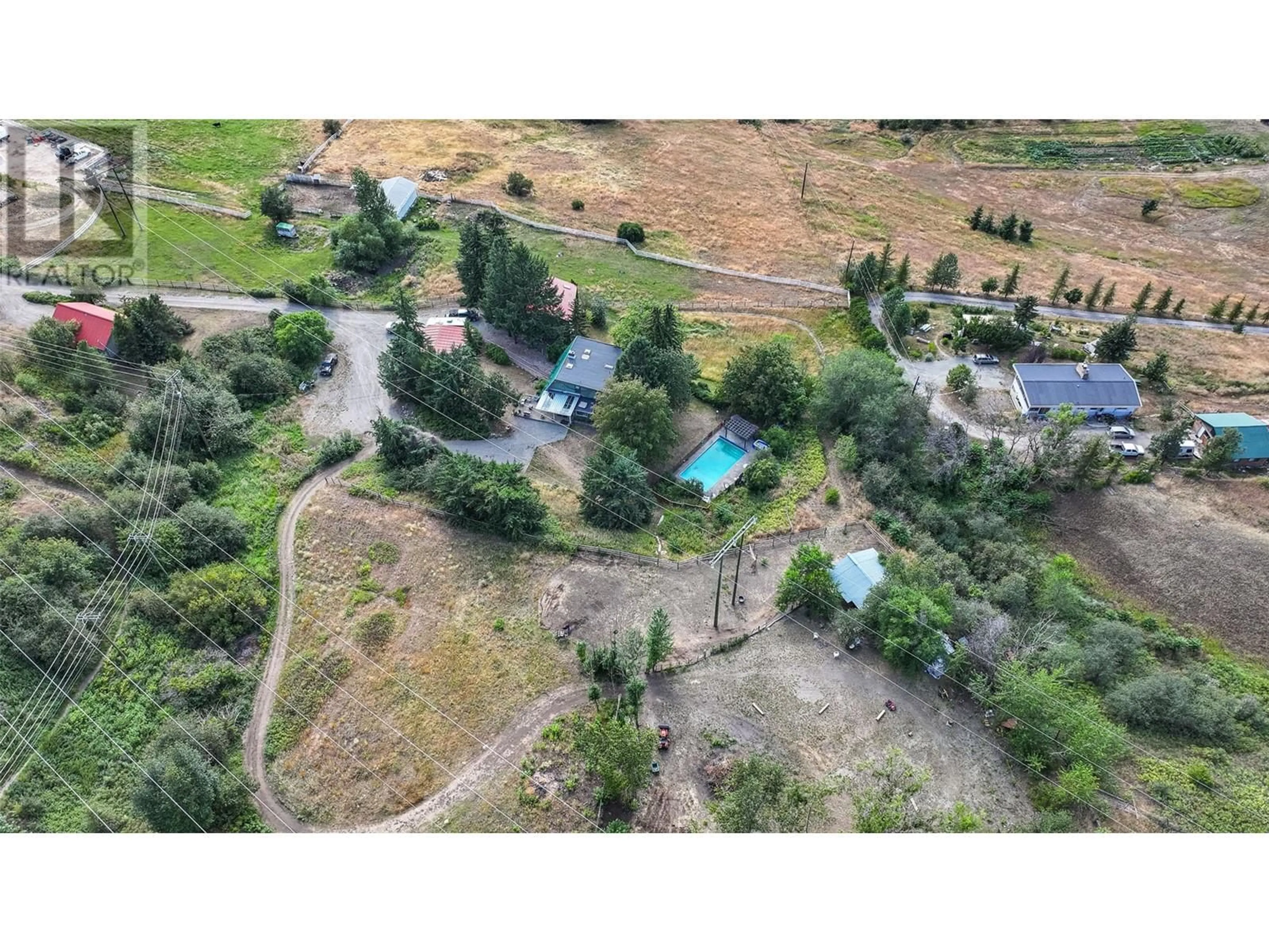 A pic from outside/outdoor area/front of a property/back of a property/a pic from drone, mountain view for 4242 DE ROO ROAD, Vernon British Columbia V1B3H7