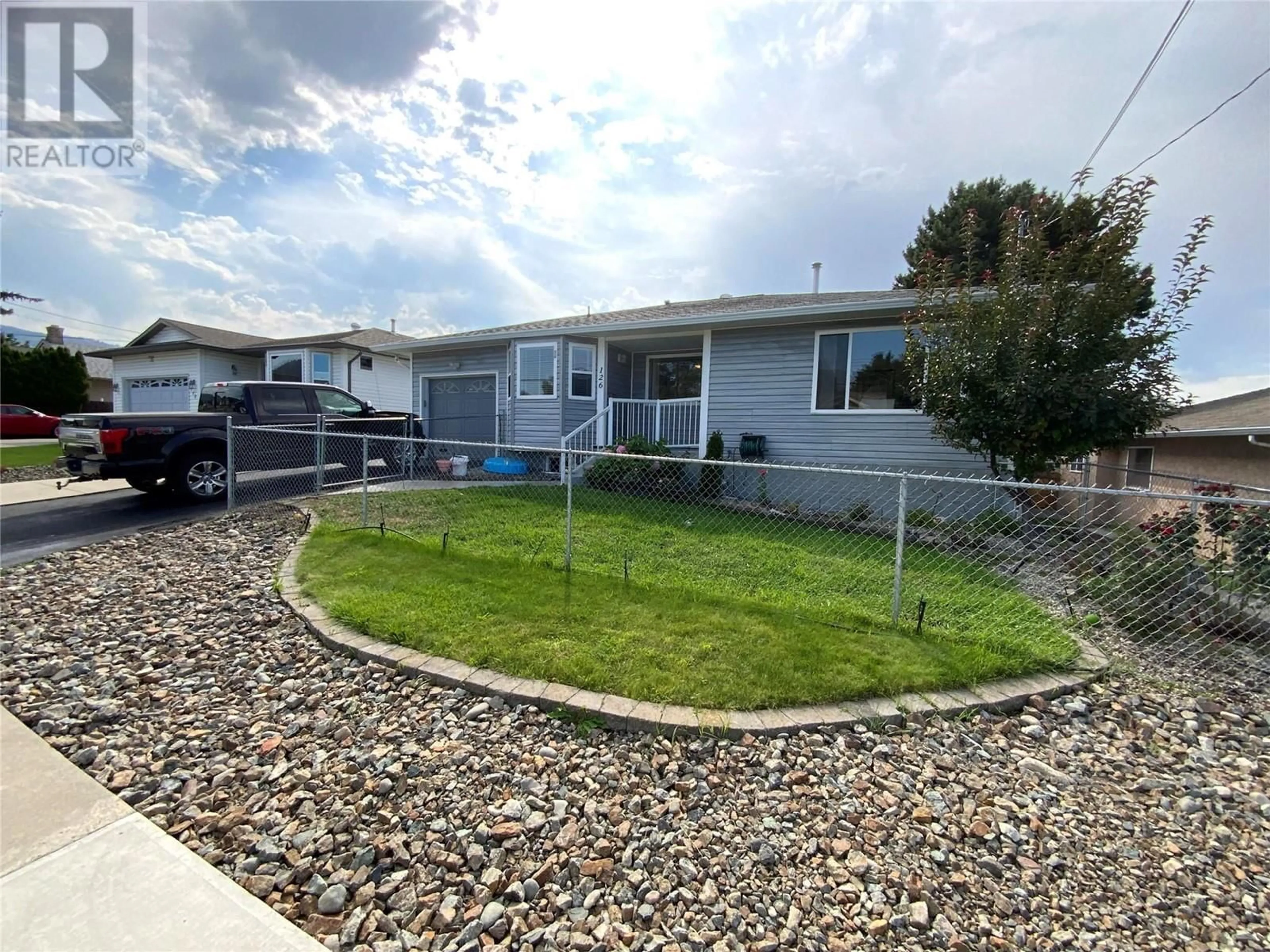 A pic from exterior of the house or condo, the fenced backyard for 126 Okanagan Avenue W, Penticton British Columbia V2A3L1