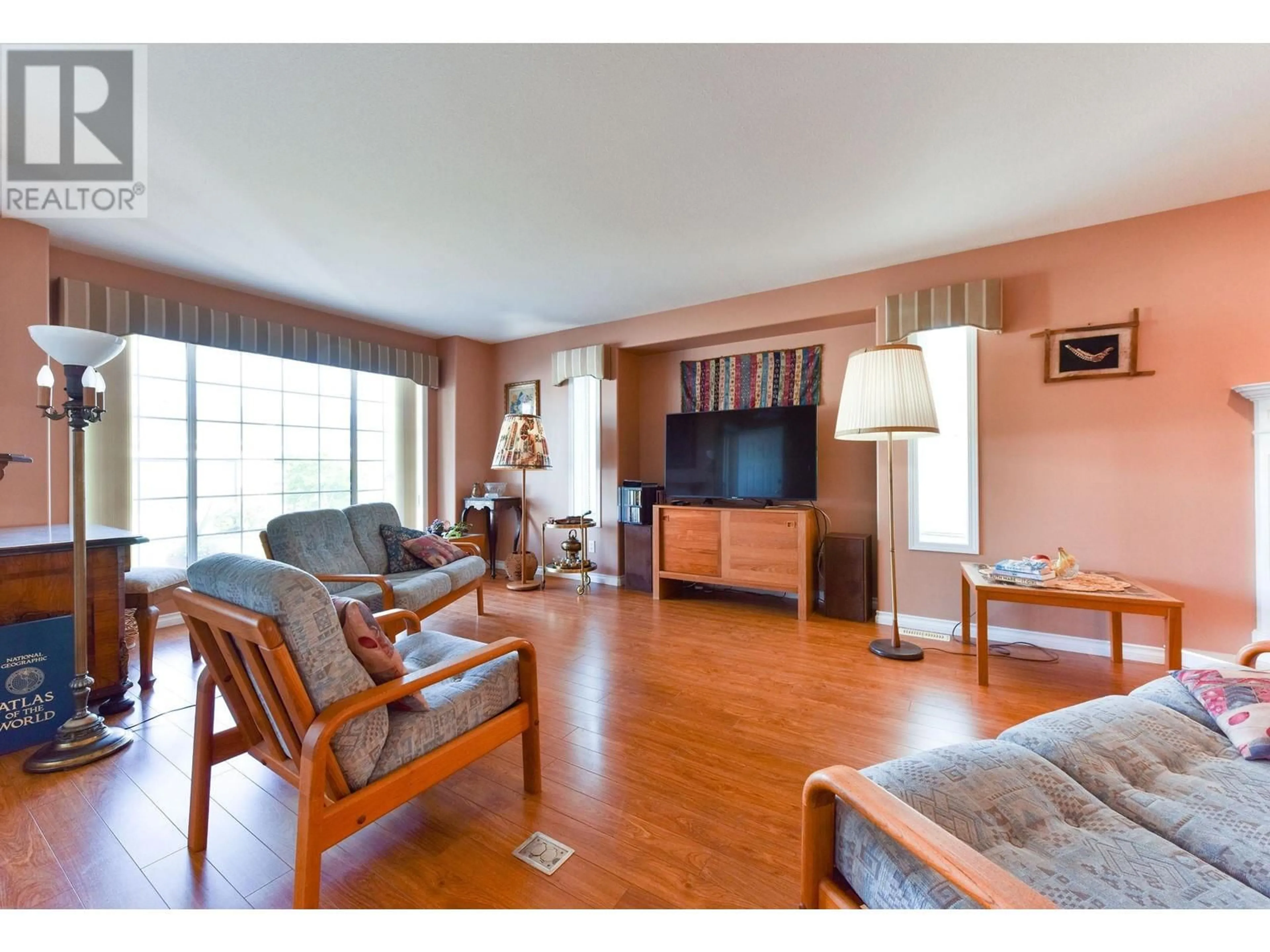 Living room with furniture, wood/laminate floor for 505 REDWING DRIVE, Penticton British Columbia V2A8N7