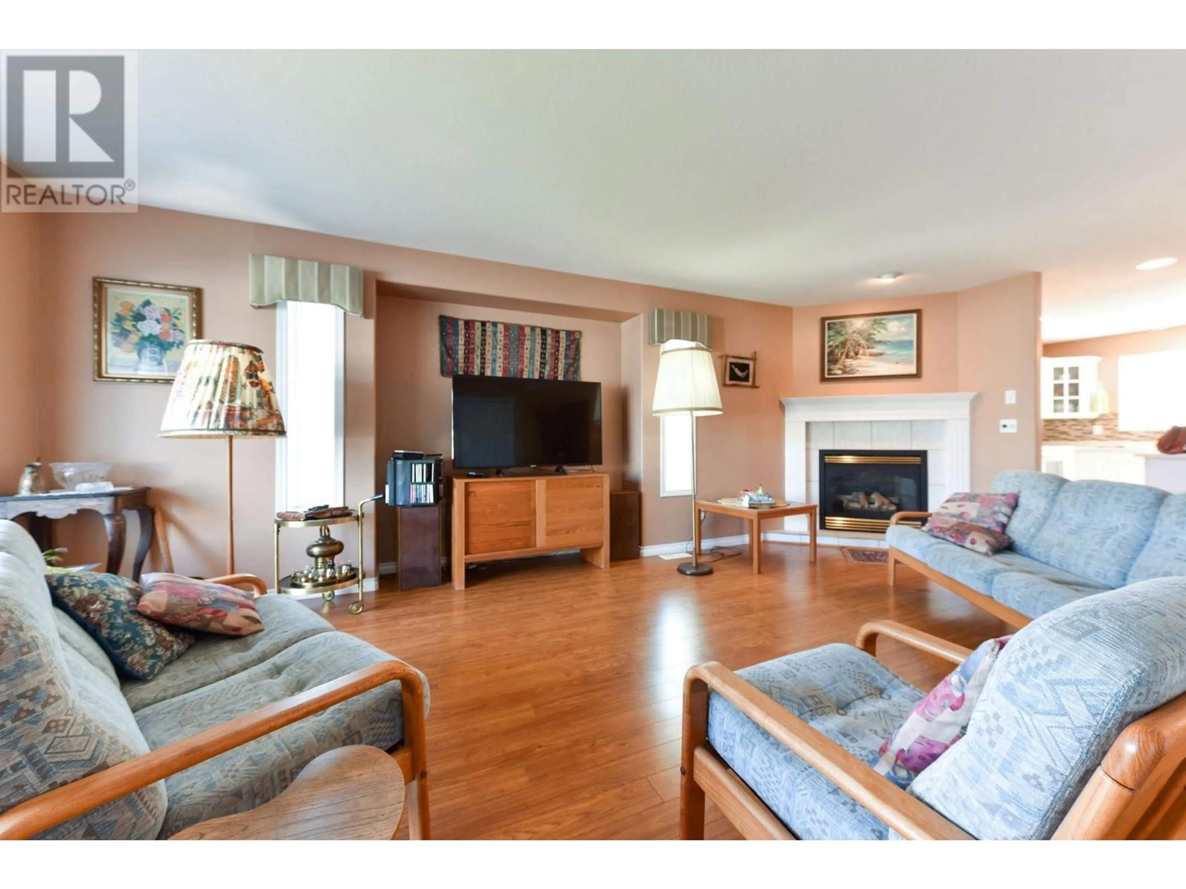 Living room with furniture, wood/laminate floor for 505 REDWING DRIVE, Penticton British Columbia V2A8N7