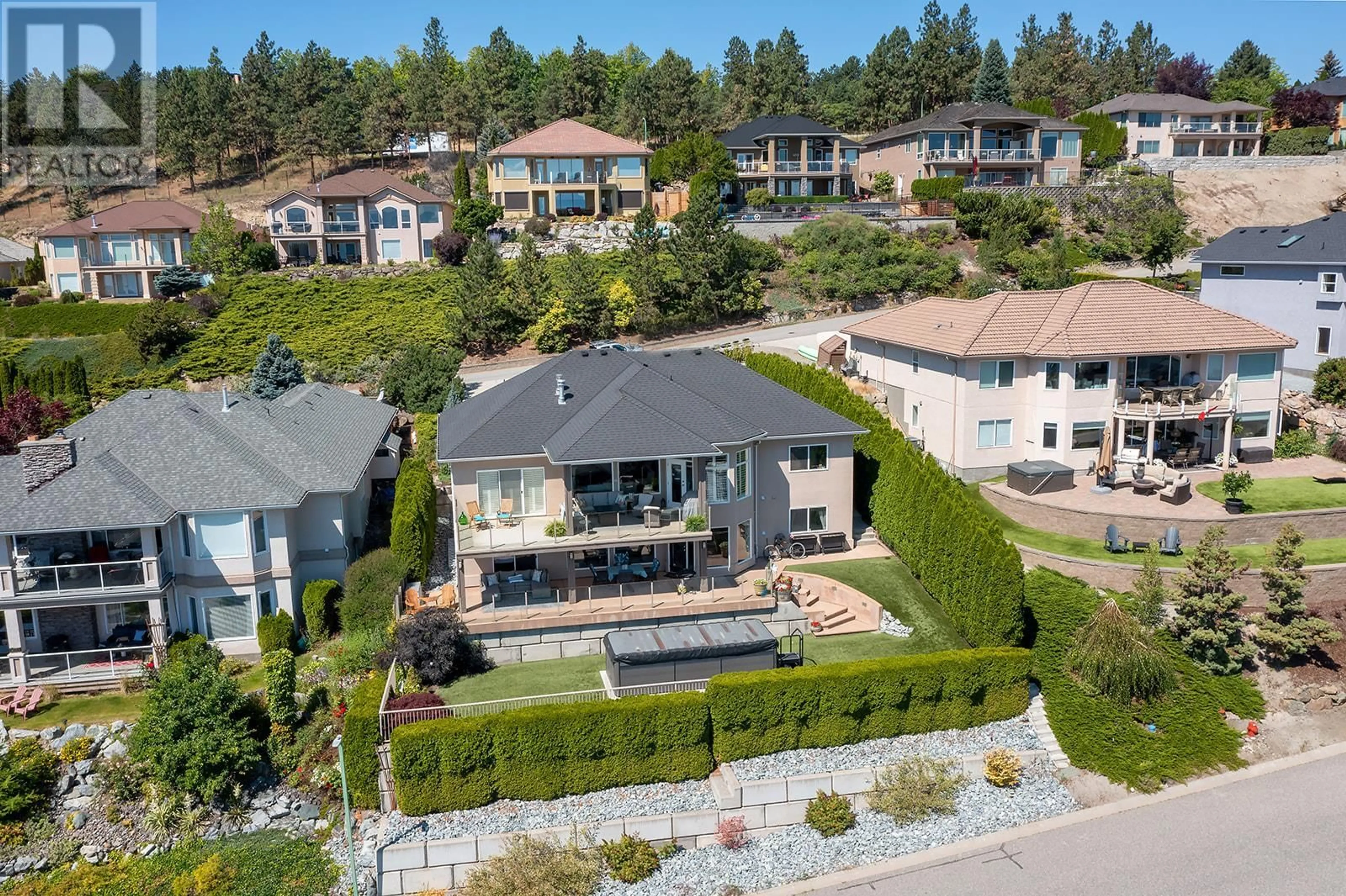 Frontside or backside of a home, the fenced backyard for 3576 Royal Gala Drive, West Kelowna British Columbia V4T2M4