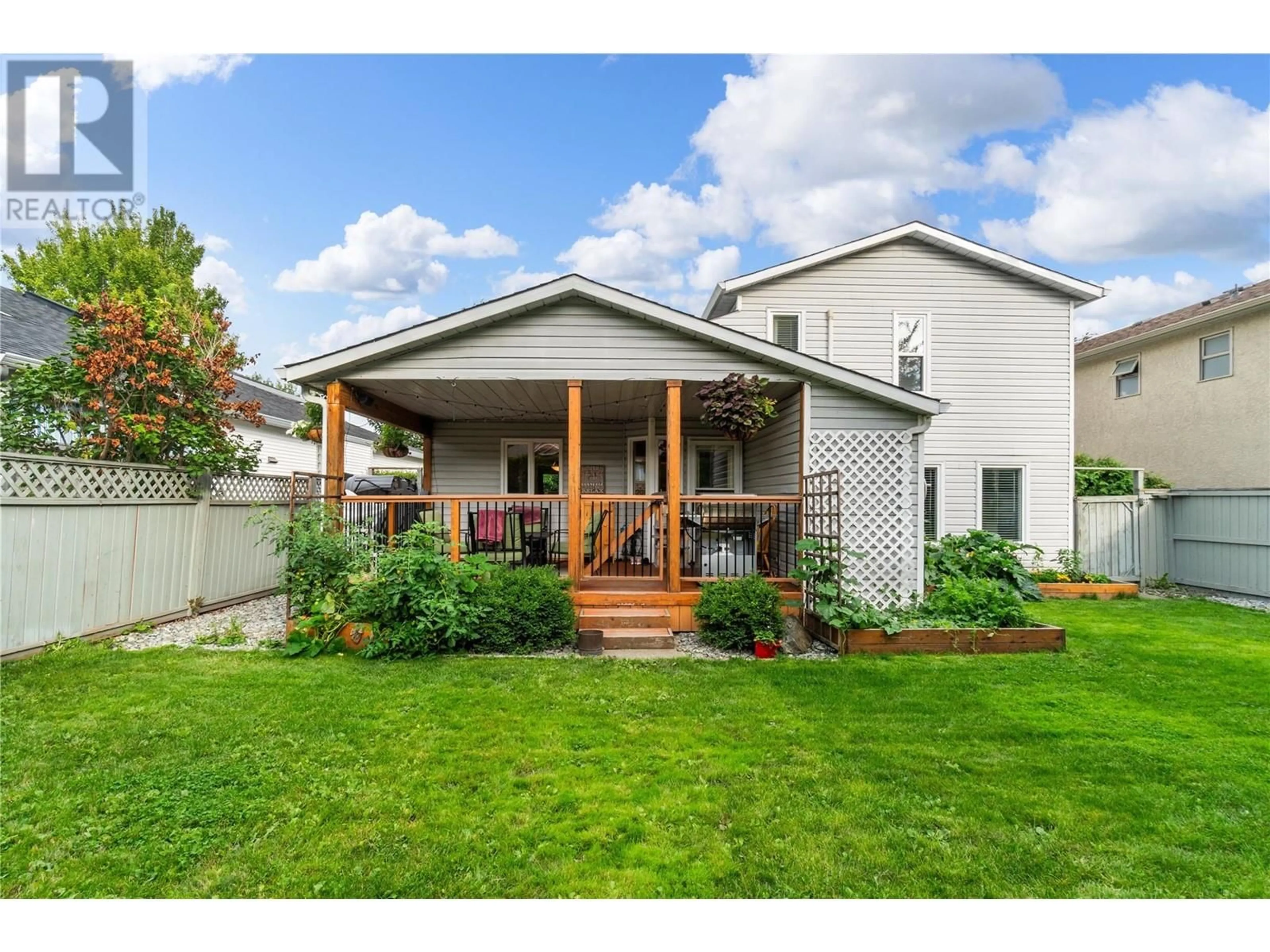 Frontside or backside of a home, the fenced backyard for 284 Drysdale Boulevard, Kelowna British Columbia V1V1P5