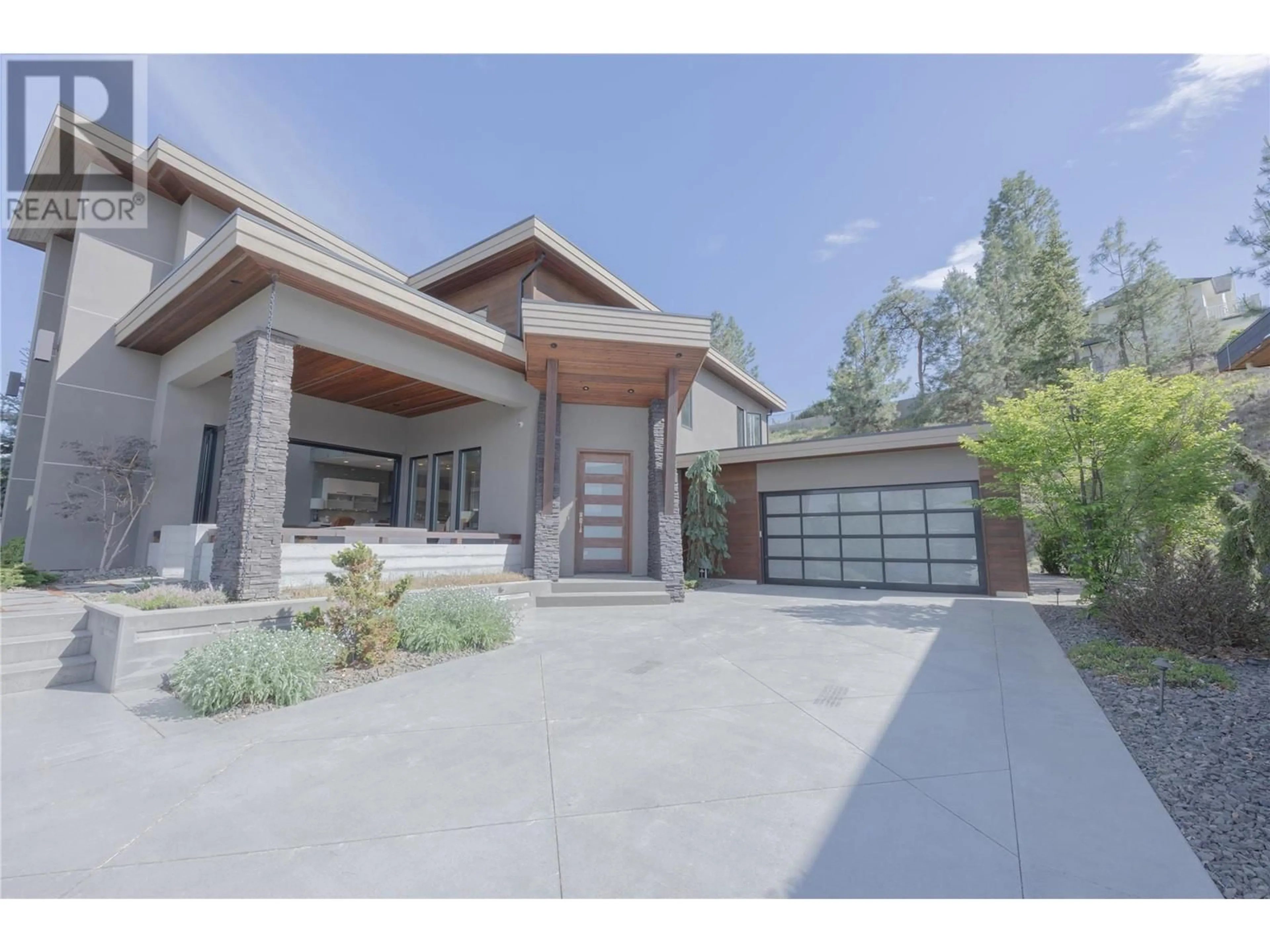 Frontside or backside of a home, the street view for 1067 Westpoint Drive, Kelowna British Columbia V1W4Z9