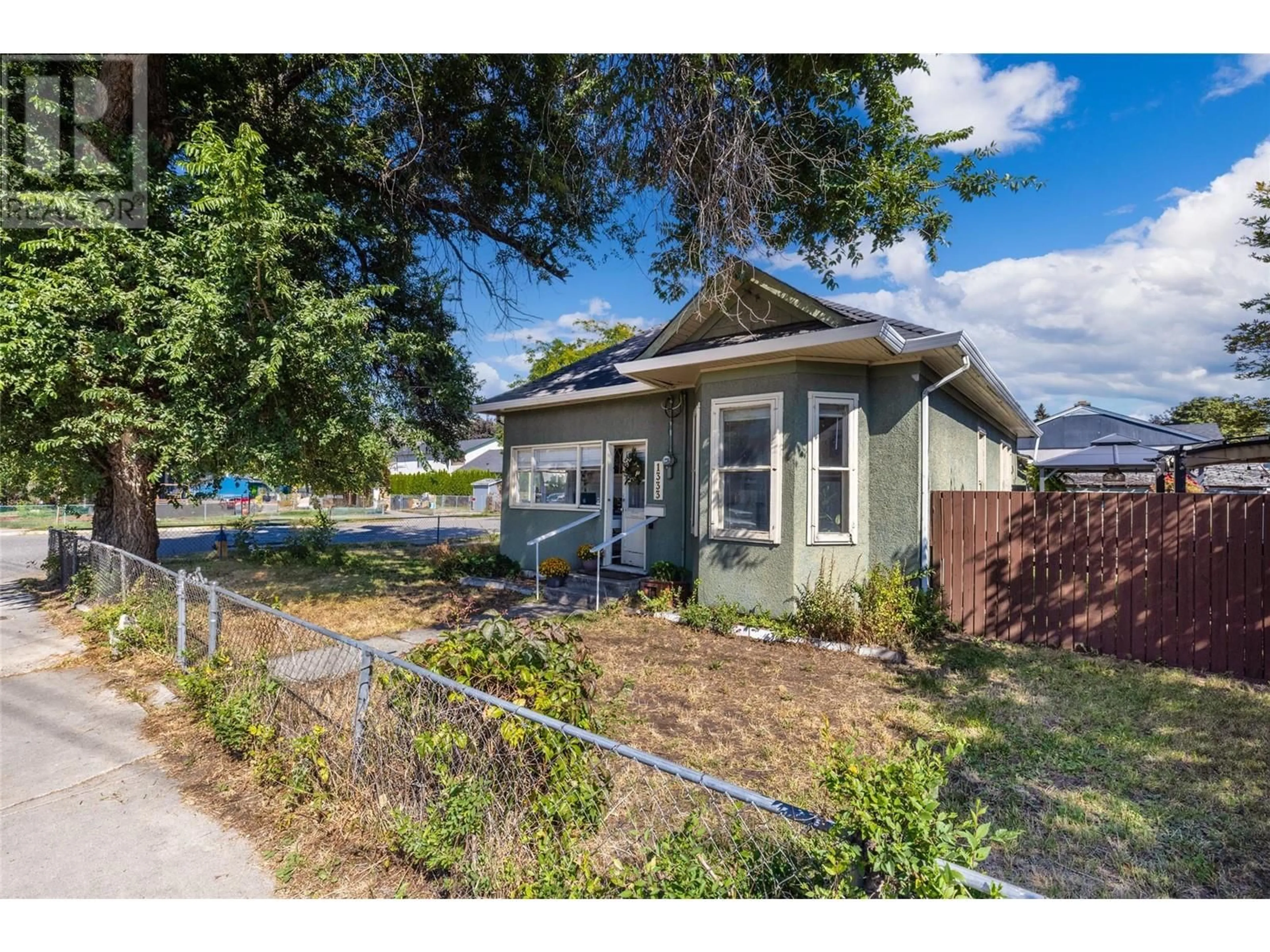 Frontside or backside of a home, the fenced backyard for 1333 Richter Street, Kelowna British Columbia V1Y2L5