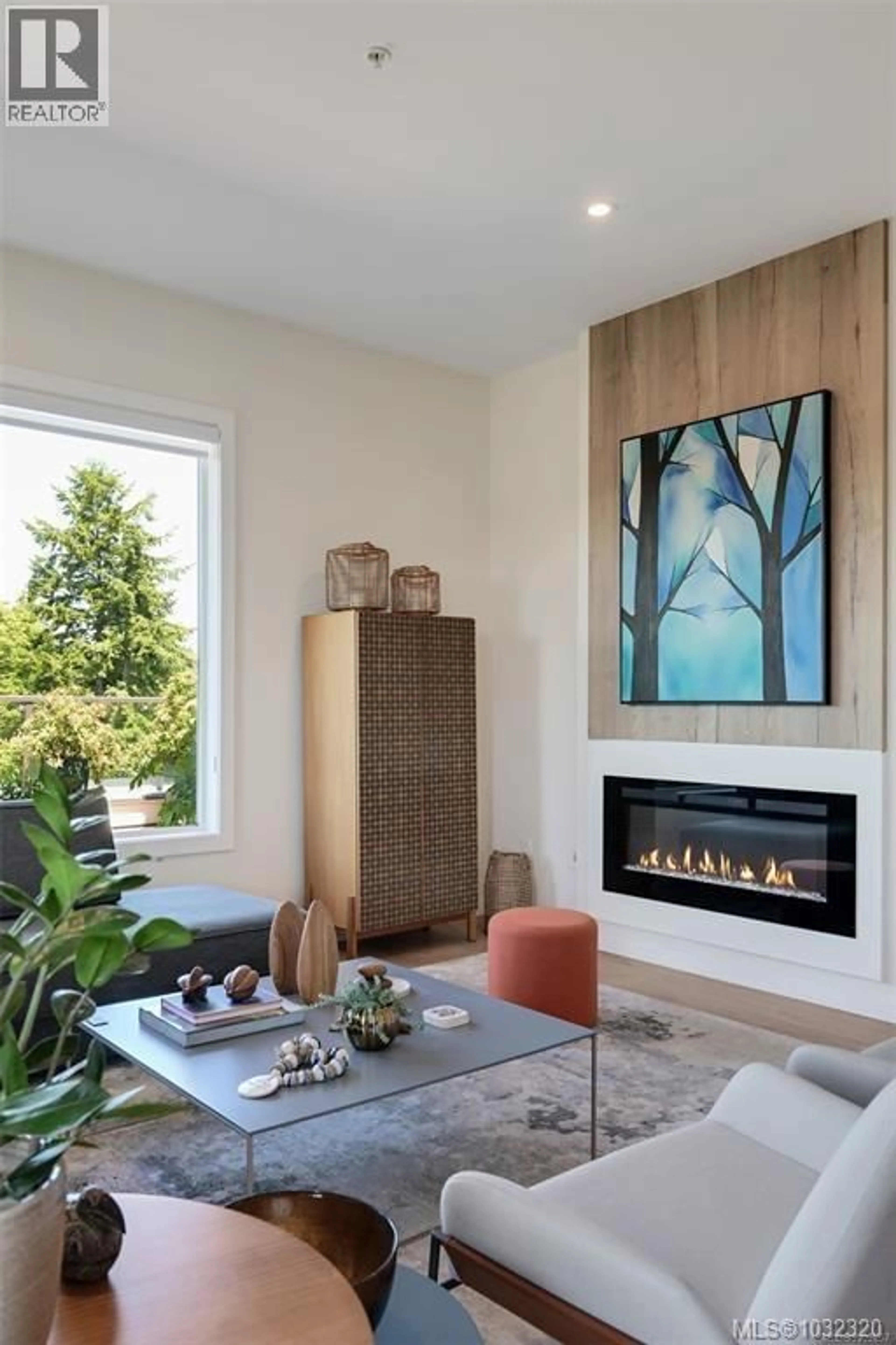 Living room with furniture, wood/laminate floor for 409 - 1588 NORTH DAIRY ROAD, Saanich British Columbia V8T3V4