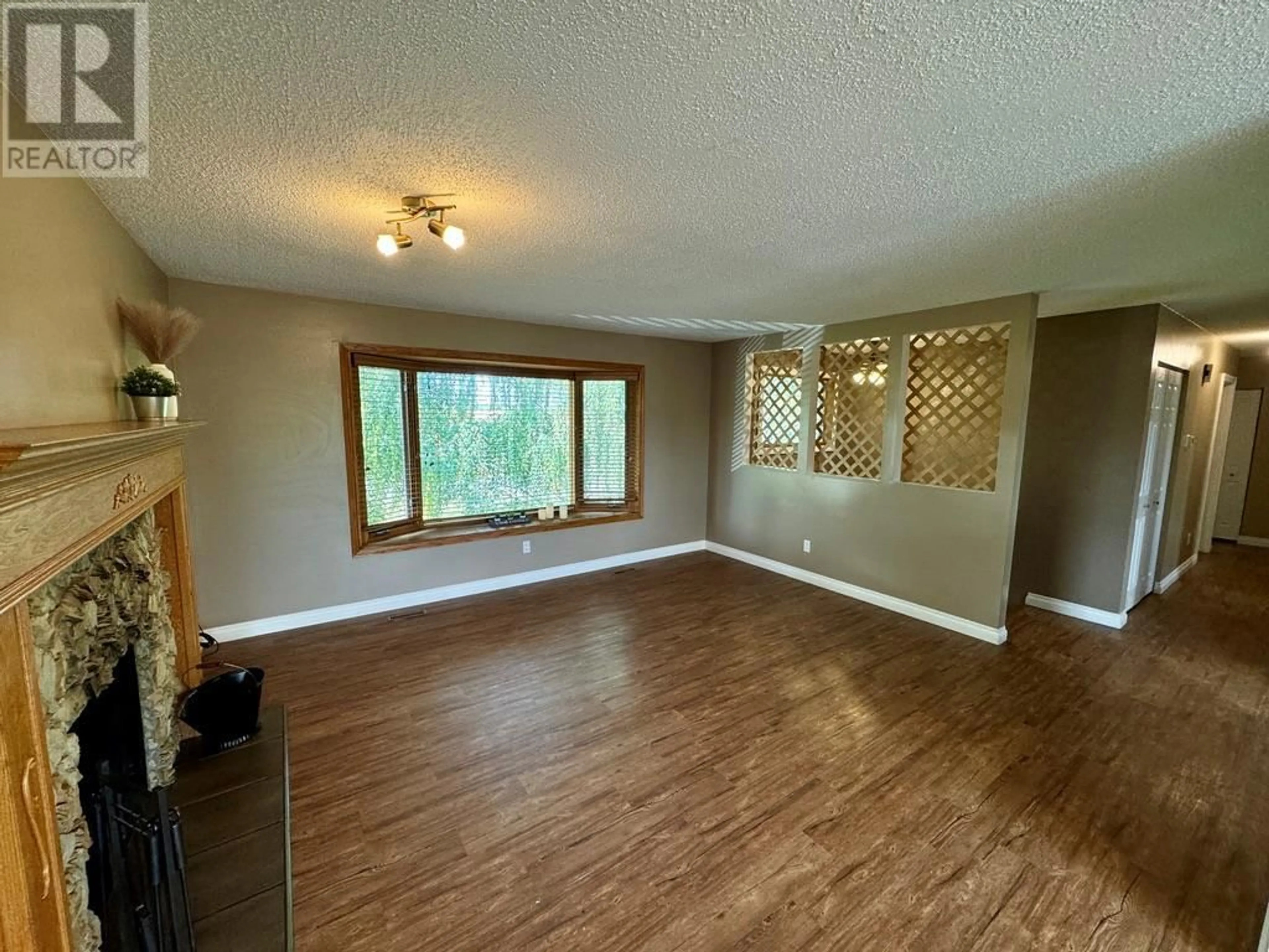 A pic of a room, wood floors for 11328 17 Street, Dawson Creek British Columbia V1G4J5