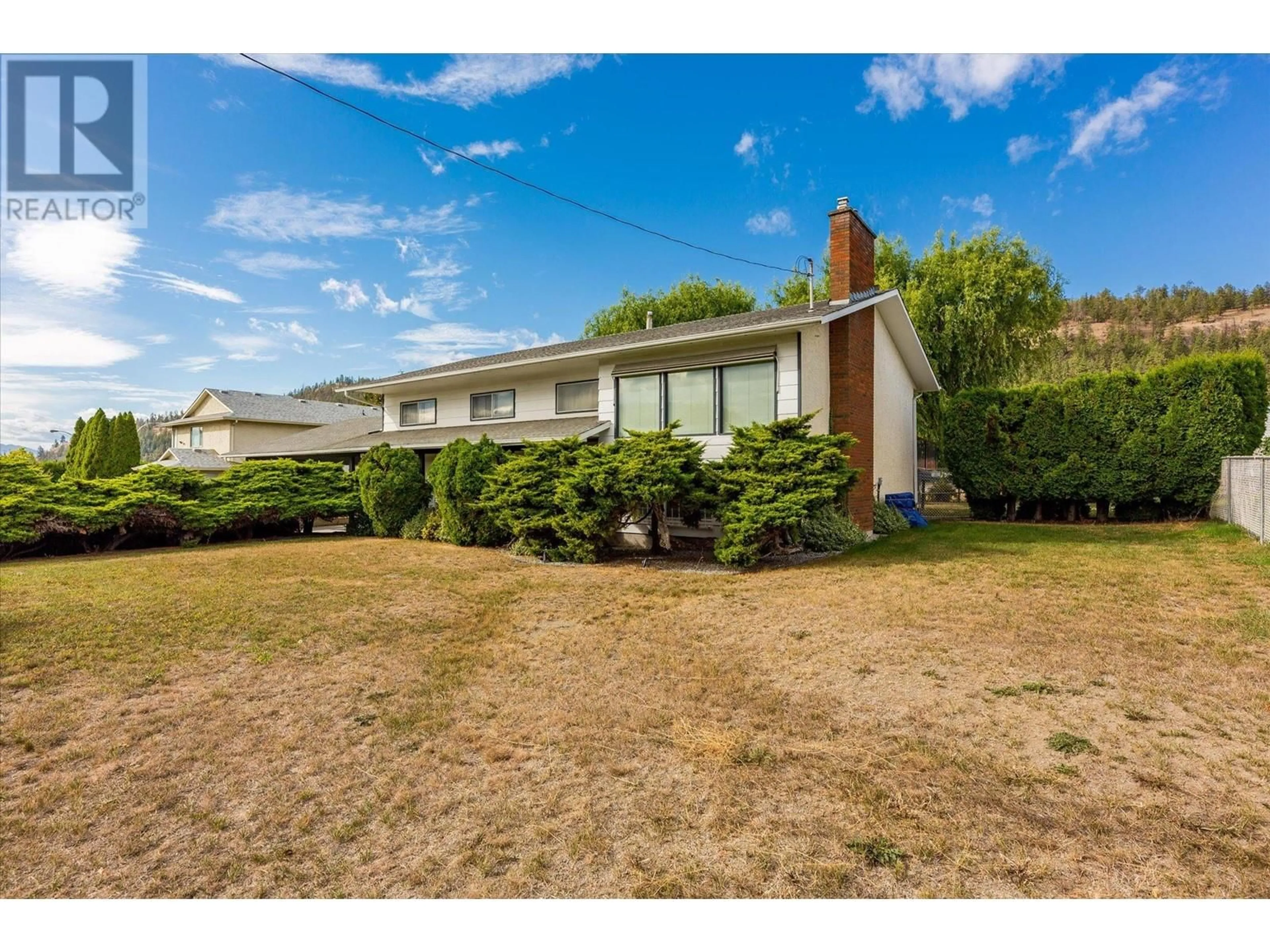 Frontside or backside of a home, the fenced backyard for 328 Glenmore Road, Kelowna British Columbia V1V1P2