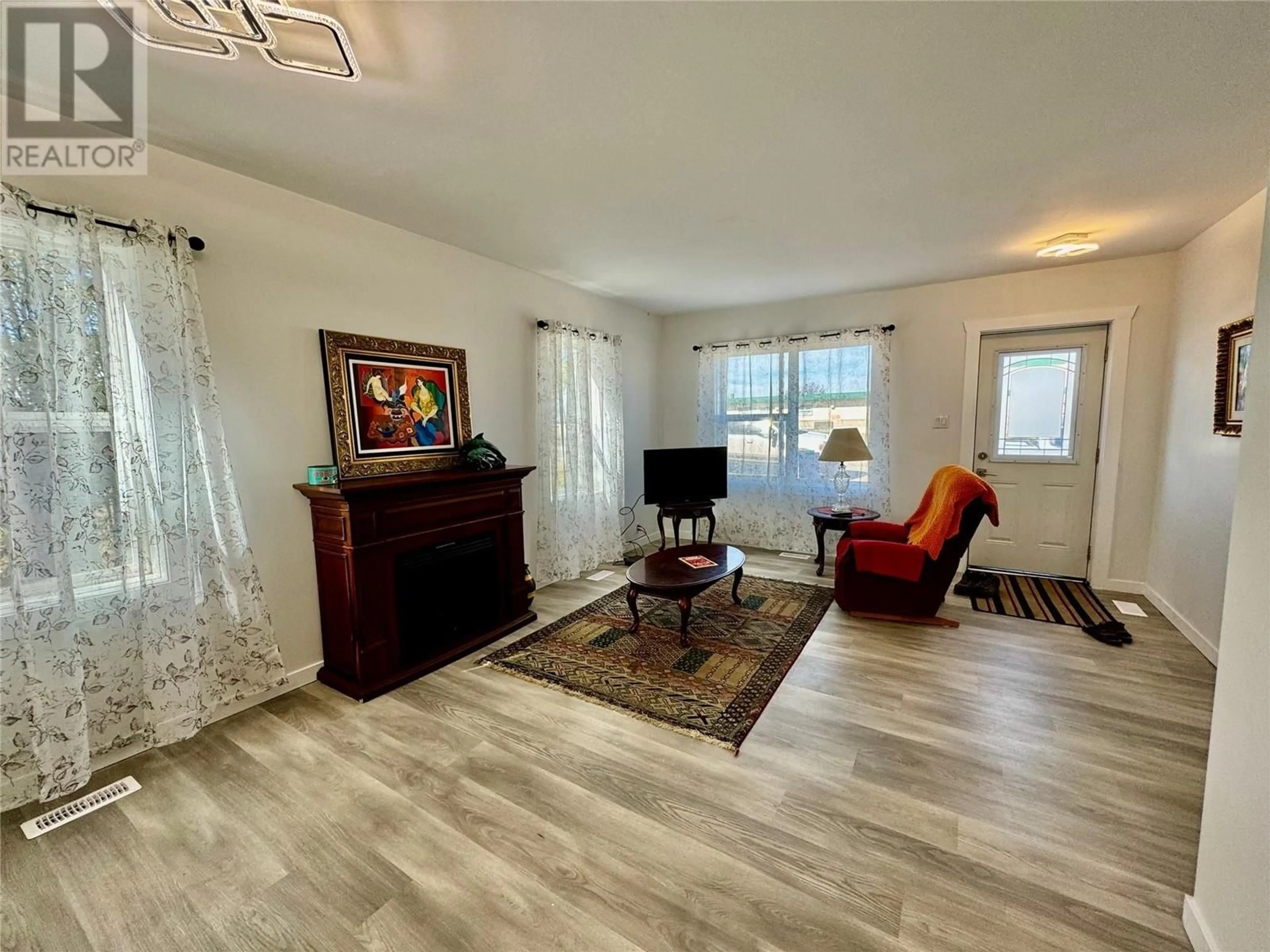 Living room with furniture, wood/laminate floor for 5013 52 AVENUE, Pouce Coupe British Columbia V0C2C0