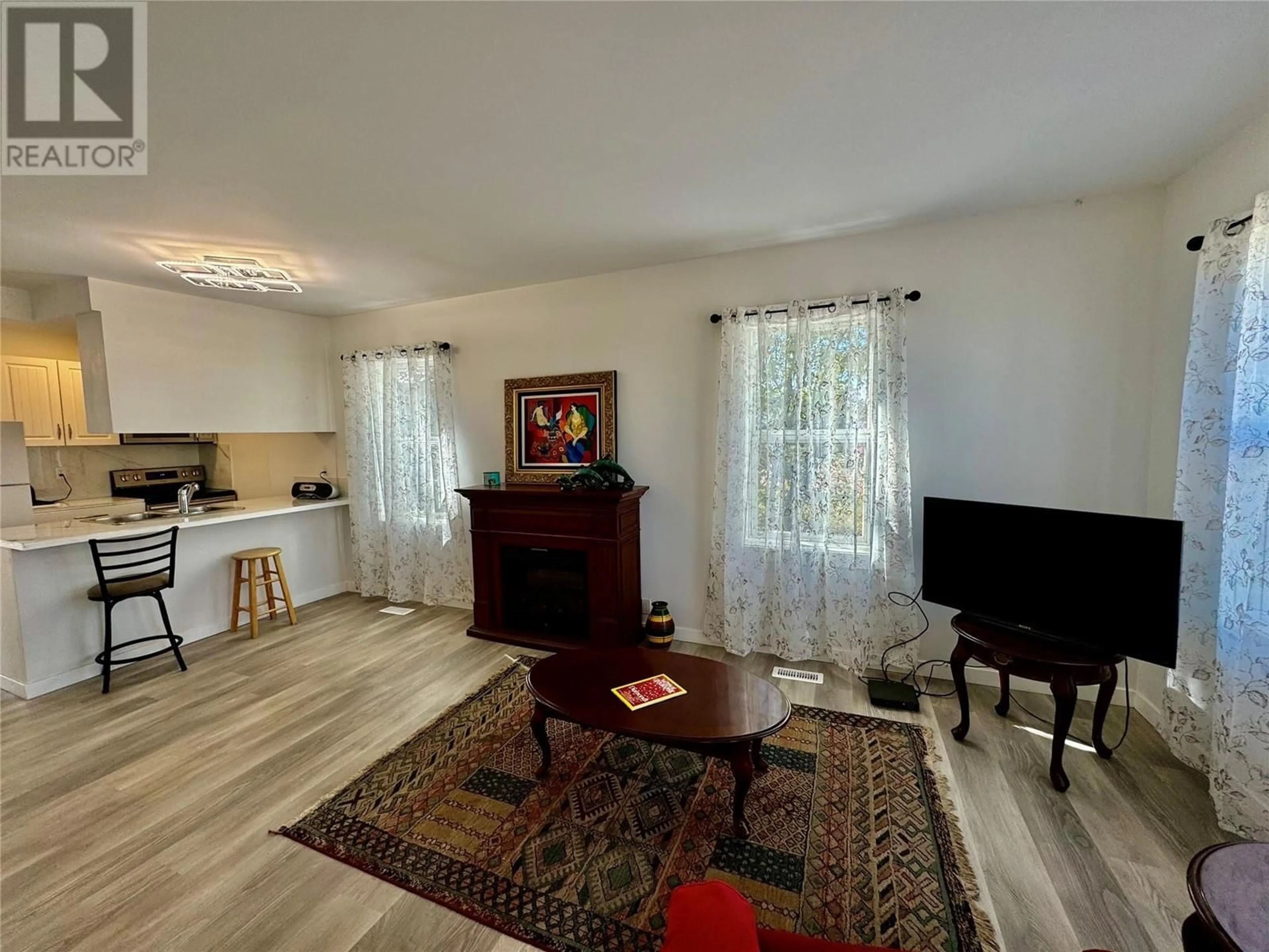 Living room with furniture, wood/laminate floor for 5013 52 Avenue, Pouce Coupe British Columbia V0C2C0