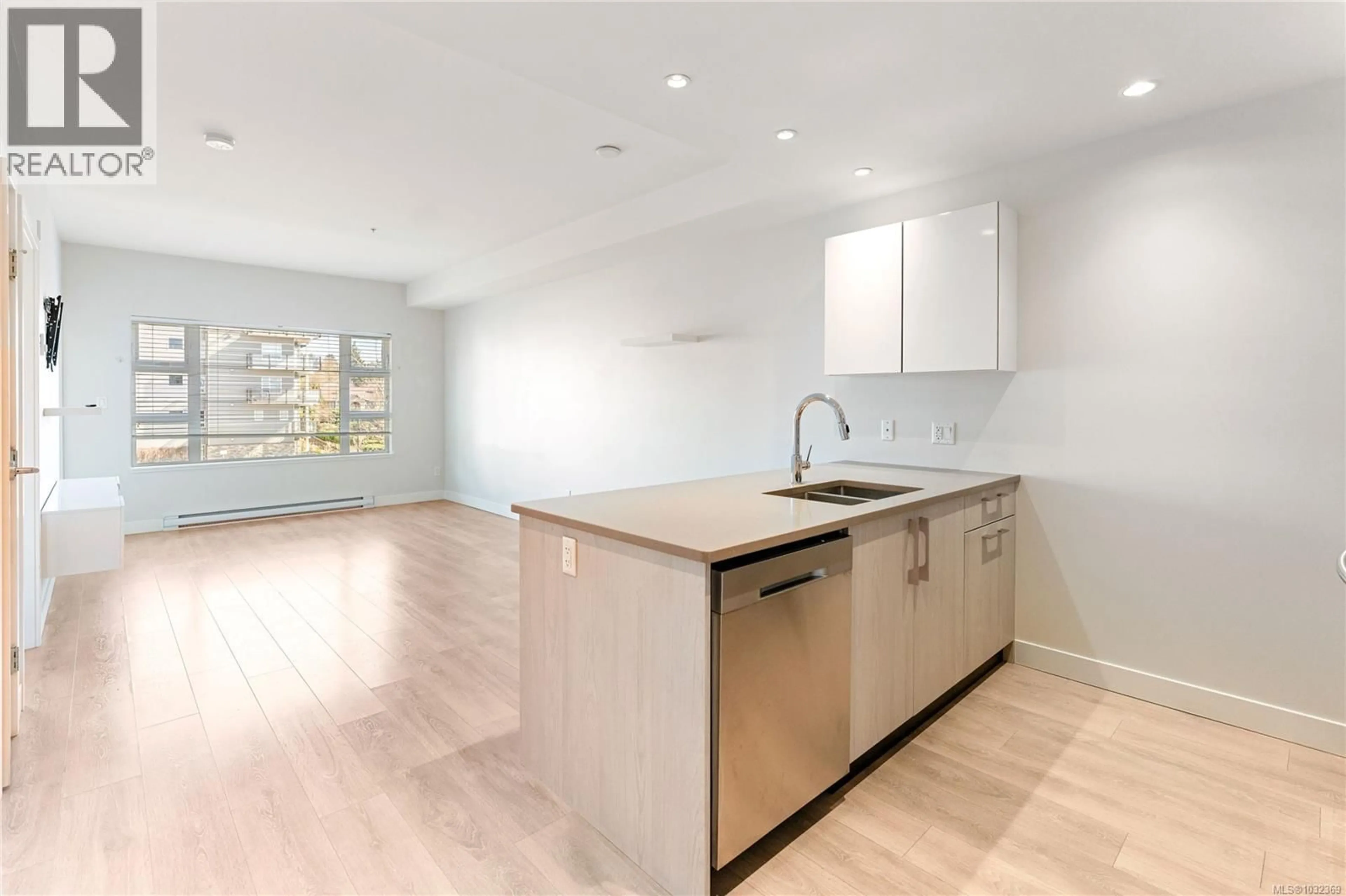 Open concept kitchen, wood/laminate floor for 304 - 3333 GLASGOW AVENUE, Saanich British Columbia V8X1M5