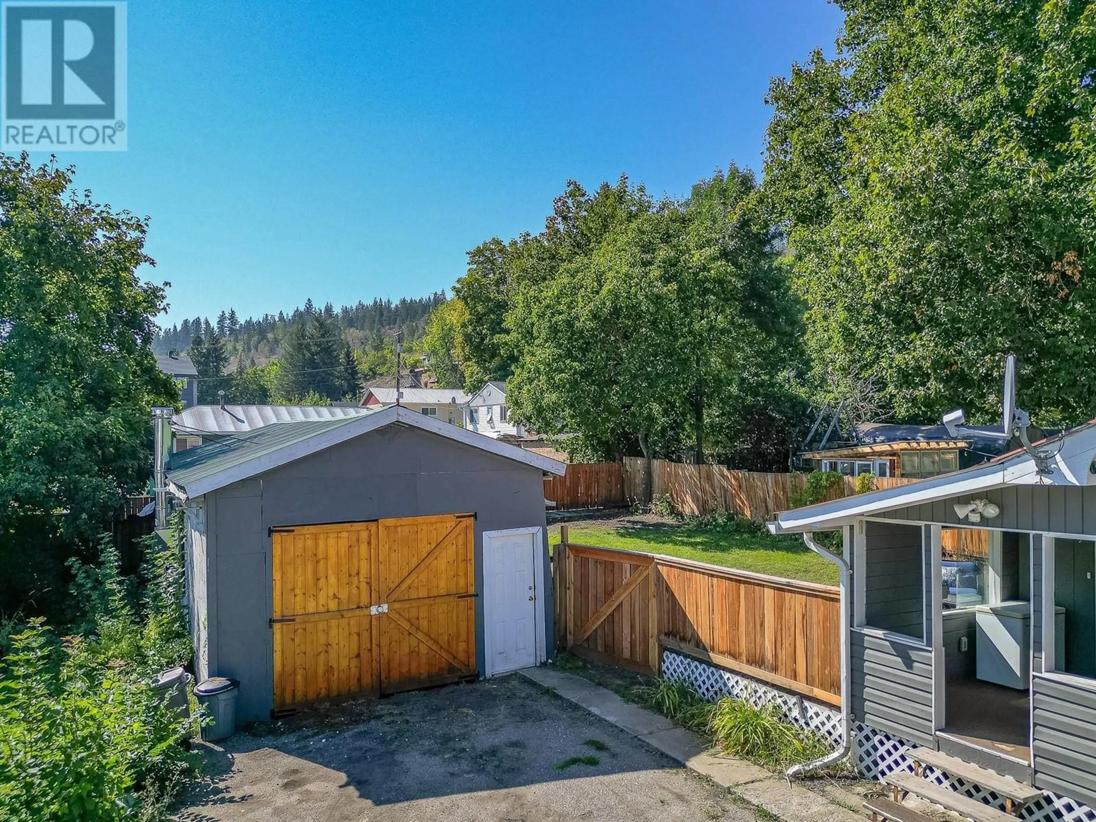 Frontside or backside of a home, the fenced backyard for 712 Hubert Avenue, Enderby British Columbia V0E1V0