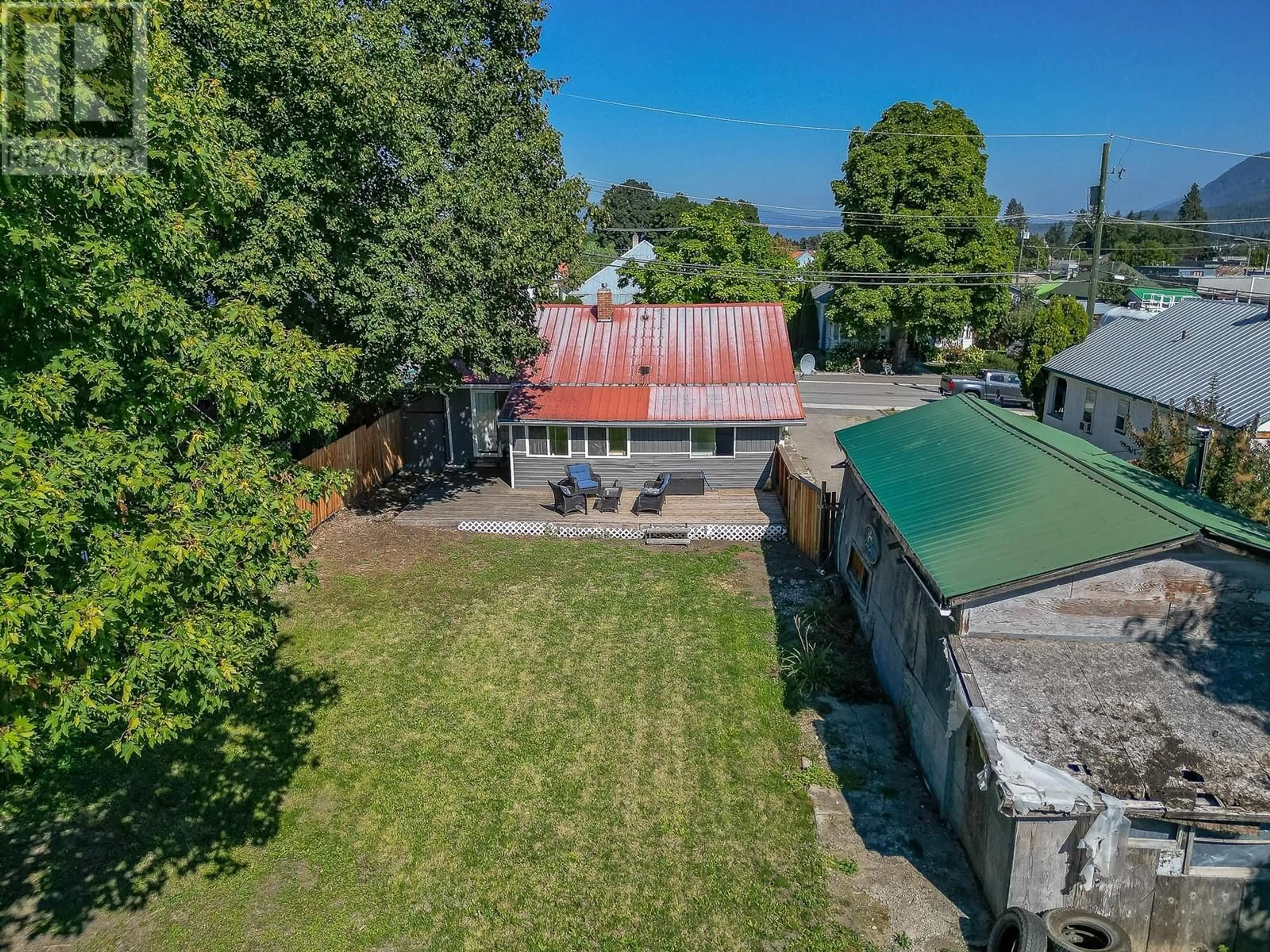 Frontside or backside of a home, the fenced backyard for 712 Hubert Avenue, Enderby British Columbia V0E1V0