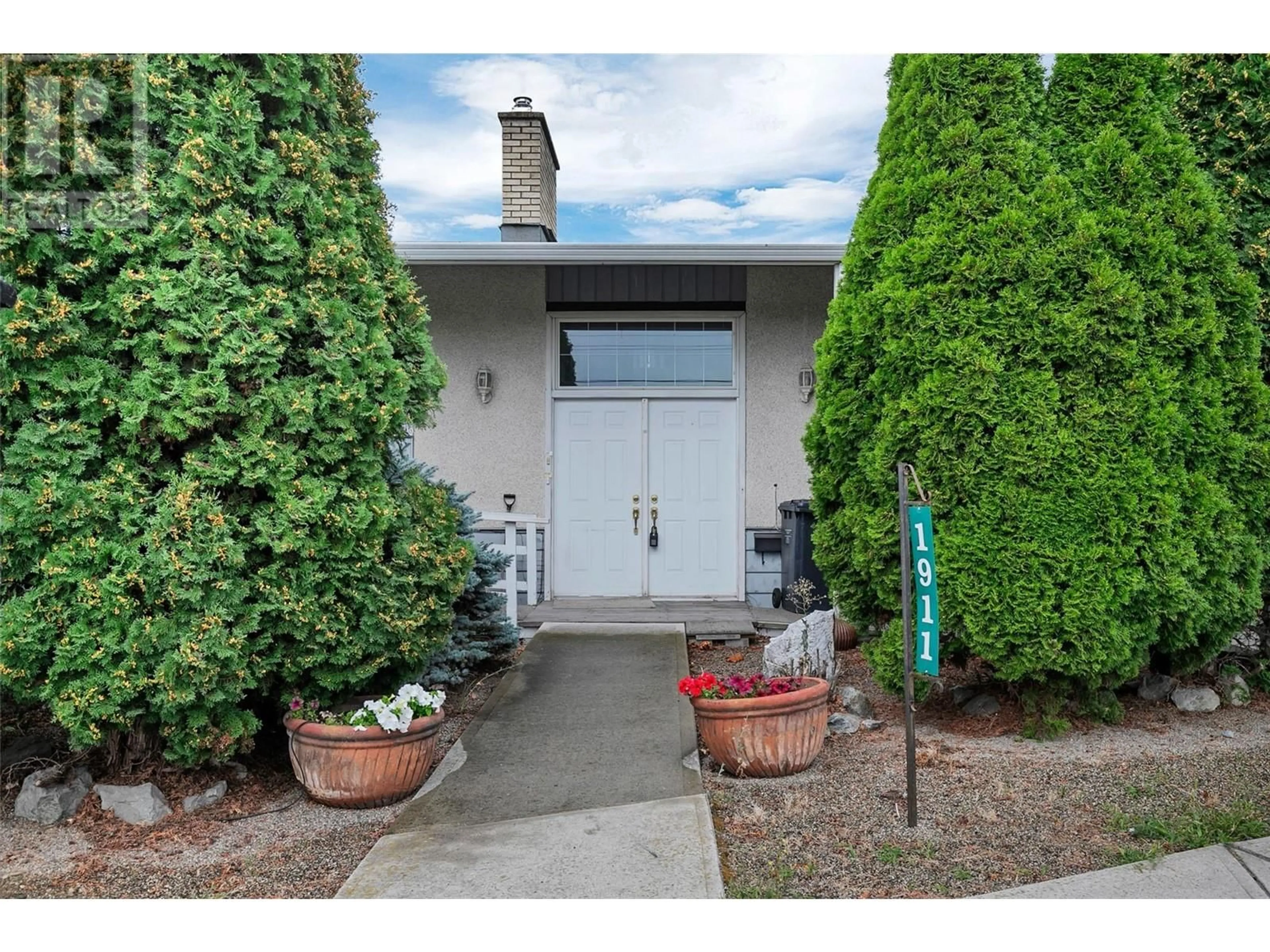 A pic from exterior of the house or condo, the street view for 1911 Cross Road, Kelowna British Columbia V1V2E4