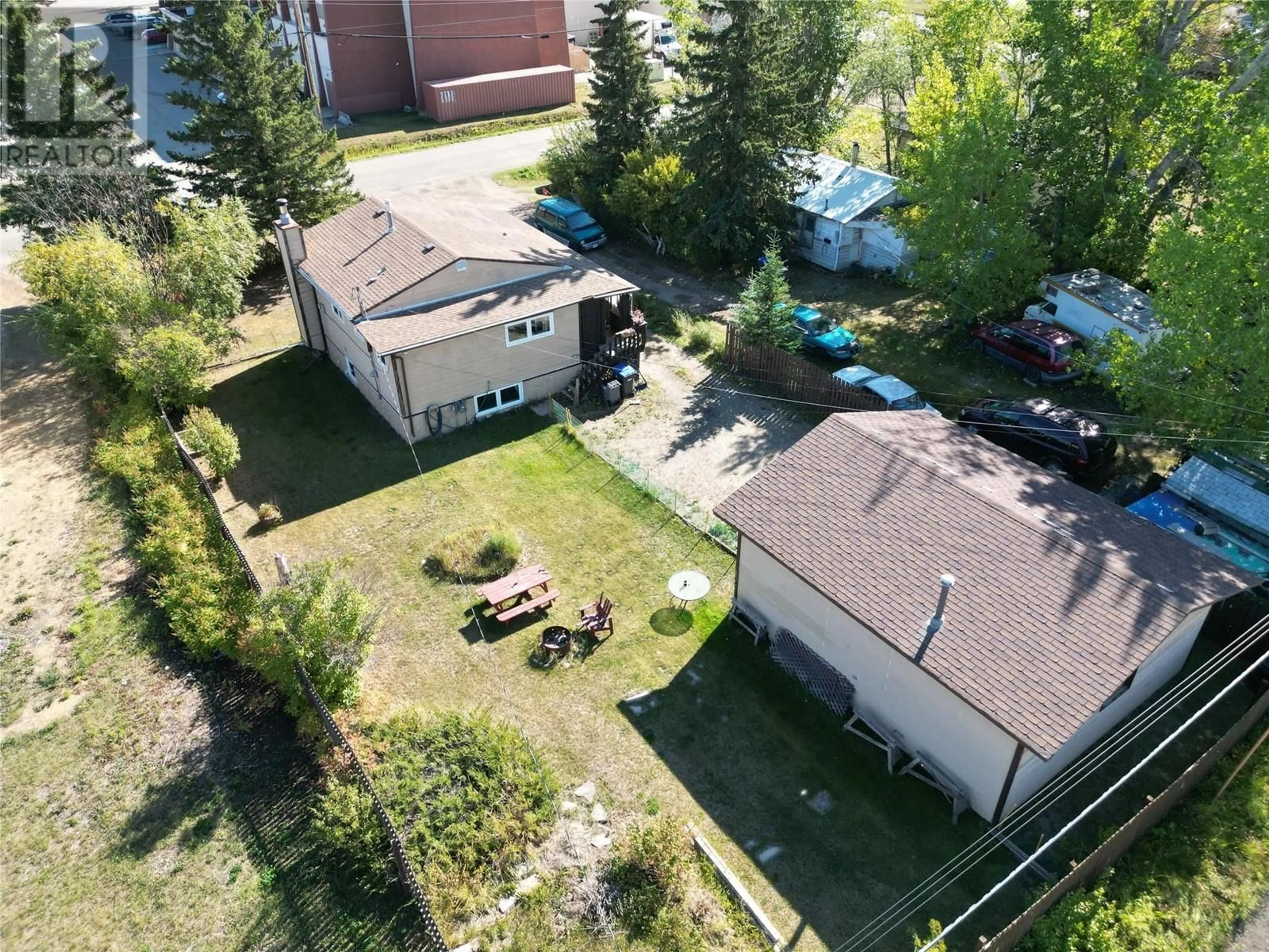 A pic from exterior of the house or condo, the fenced backyard for 11609 9 Street, Dawson Creek British Columbia V1G3S8