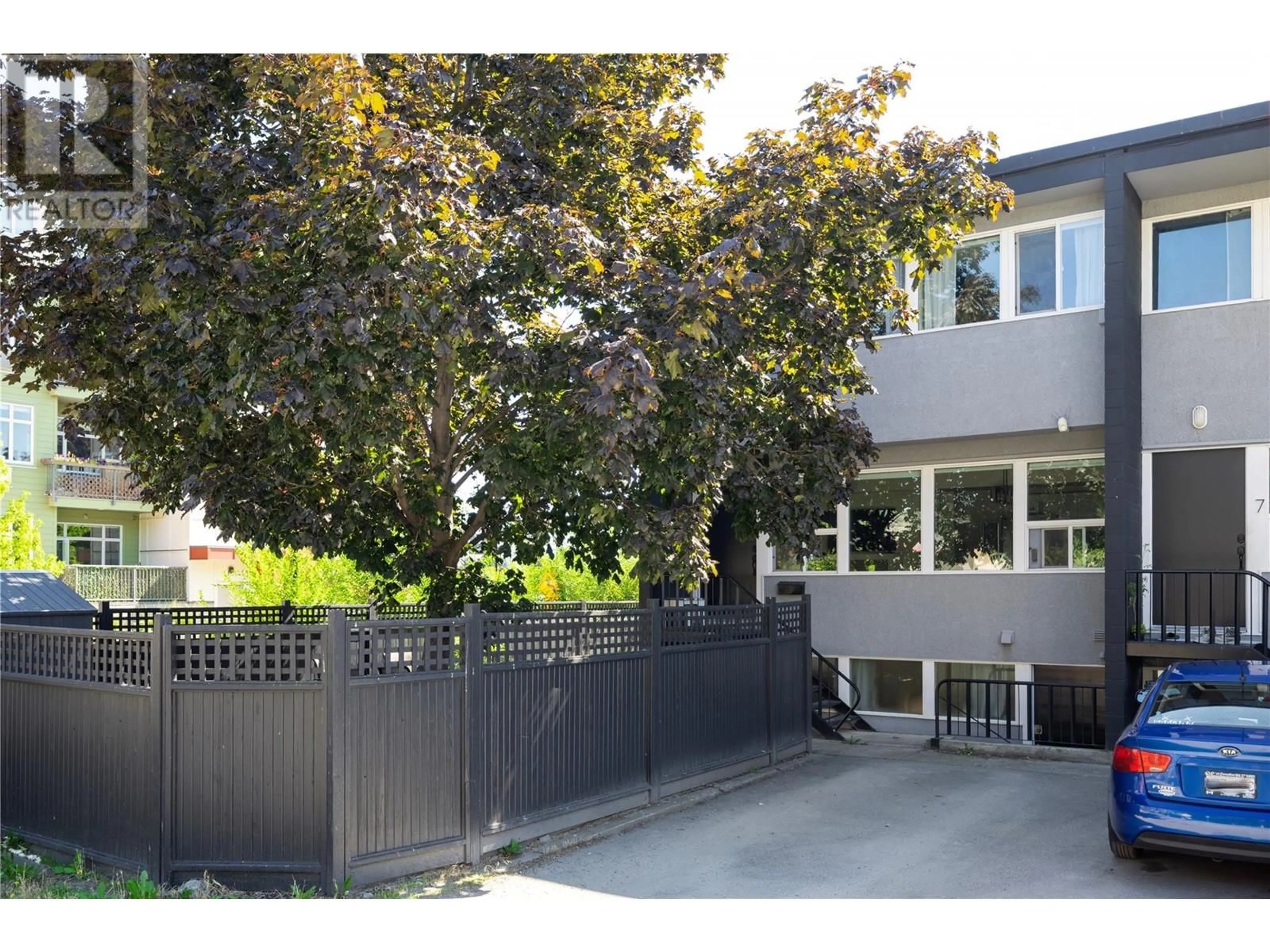 A pic from exterior of the house or condo, the fenced backyard for 545 Rosemead Avenue Unit# 9, Kelowna British Columbia V1Y5Z9