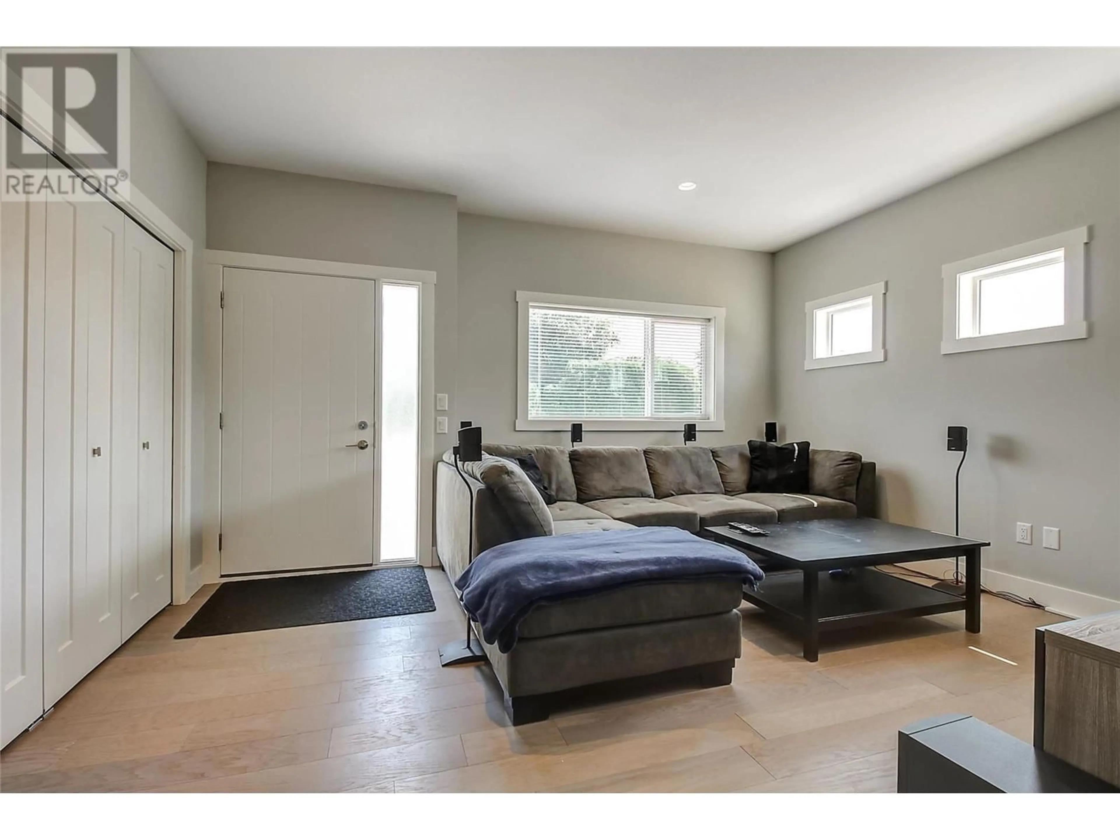 Living room with furniture, wood/laminate floor for 1480 INKAR ROAD, Kelowna British Columbia V1Y5W1