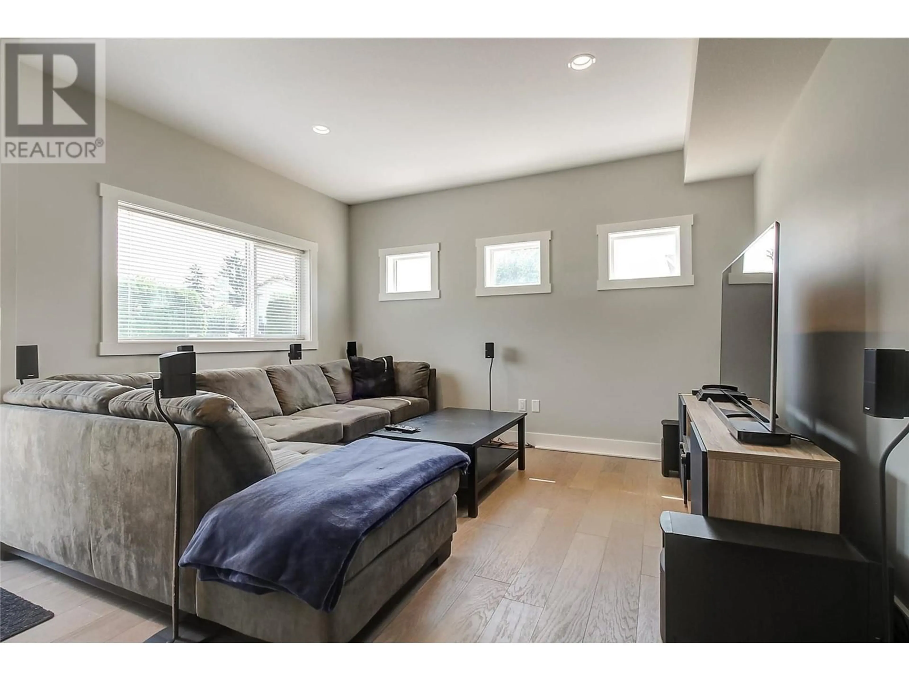 Living room with furniture, wood/laminate floor for 1480 INKAR ROAD, Kelowna British Columbia V1Y5W1
